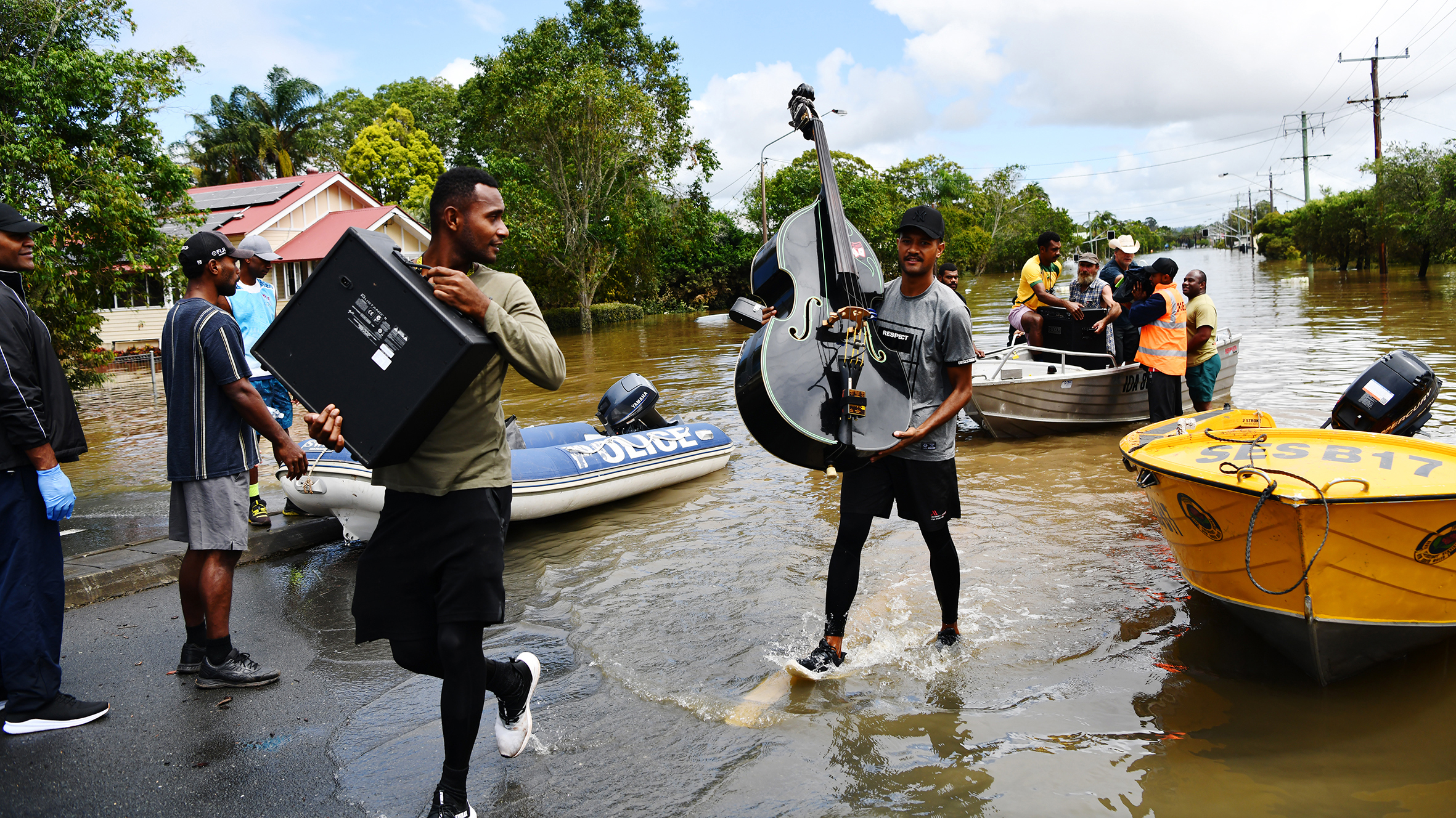 People rescue musical instruments from the floods in Lismore in northern NSW.