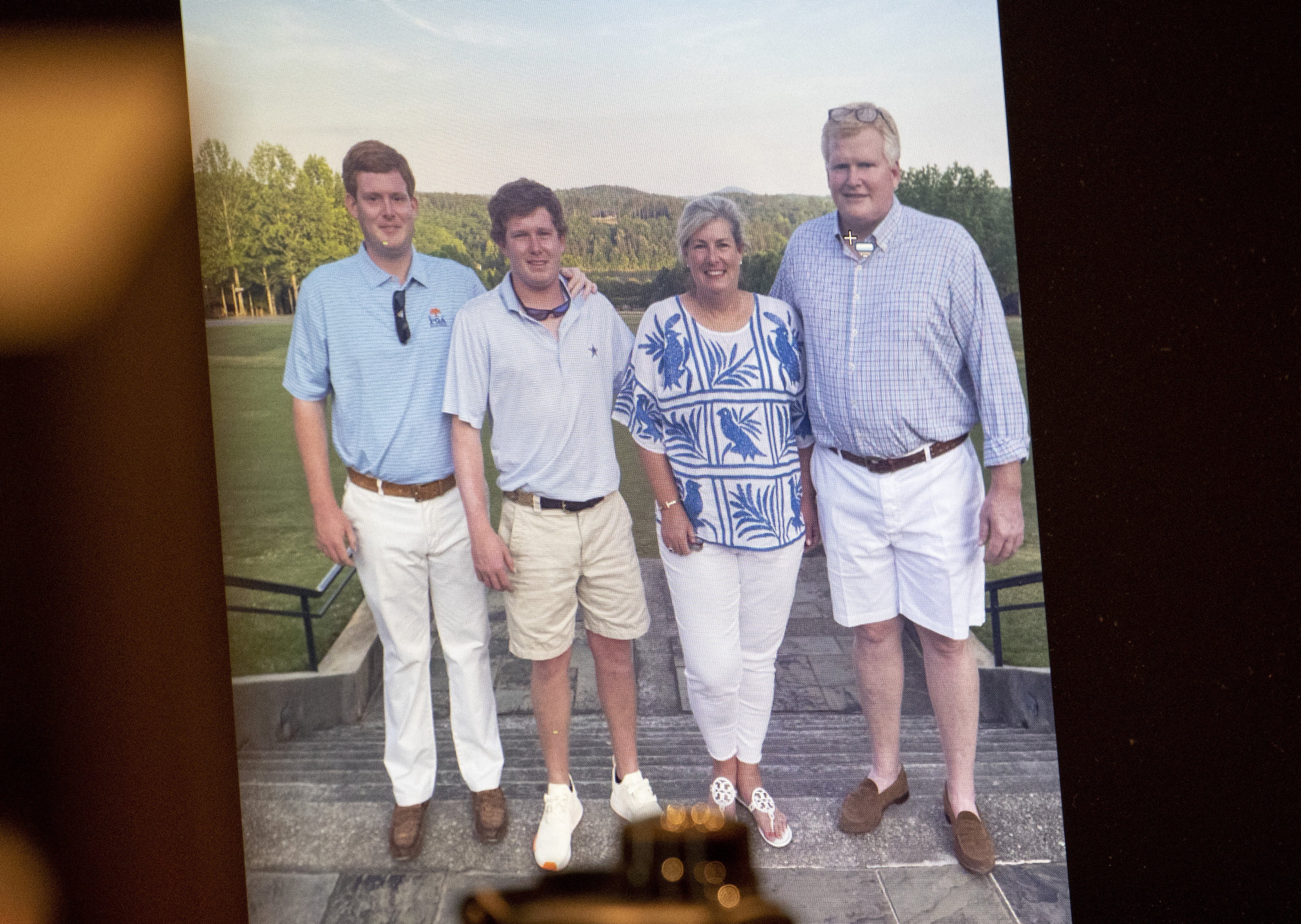 A family photo of Buster, Paul, Maggie and Alex is shown during the murder trial of Alex Murdaugh at the Colleton County Courthouse in Walterboro, S.C., on Thursday, March 2, 2023. Alex Murdaugh was sentenced to life in prison without parole Friday, a day after he was convicted of murder in the shooting deaths of his wife and son.