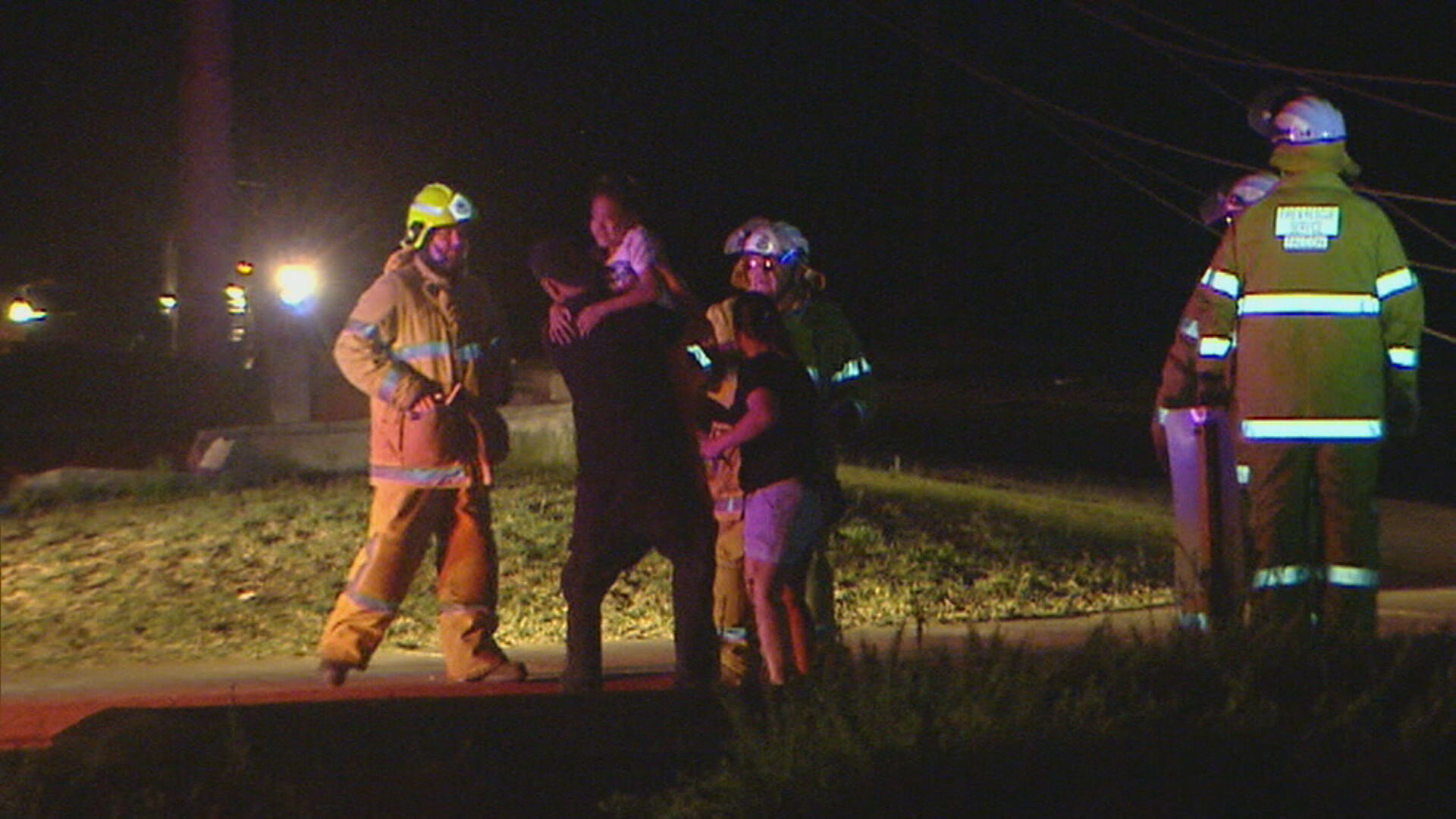 The young child and a family member share a hug after the terrifying ordeal on Anstruther Road in Mandurah. 