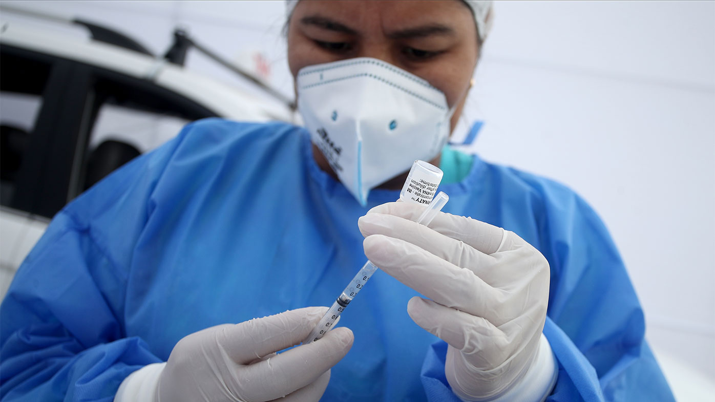 A doctor prepares a dose of Pfizer-BioNTech COVID-19 vaccine at Manuel Bonilla Stadium in Lima, Peru.