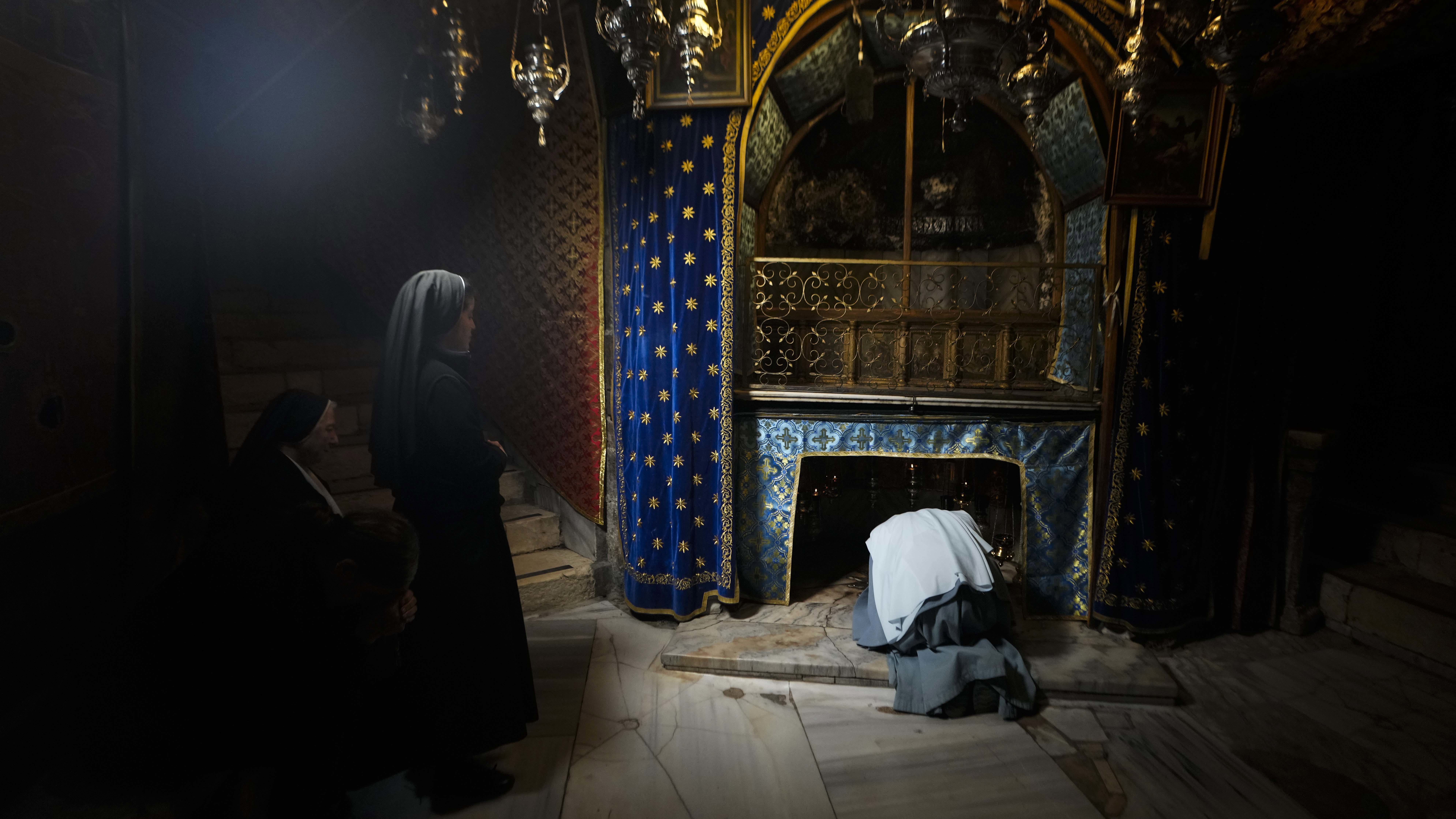 Worshippers pray at the Church of the Nativity, traditionally believed to be the birthplace of Jesus, on Christmas Eve, in the West Bank city of Bethlehem, Tuesday, Dec. 24, 2024. (AP Photo/Matias Delacroix)