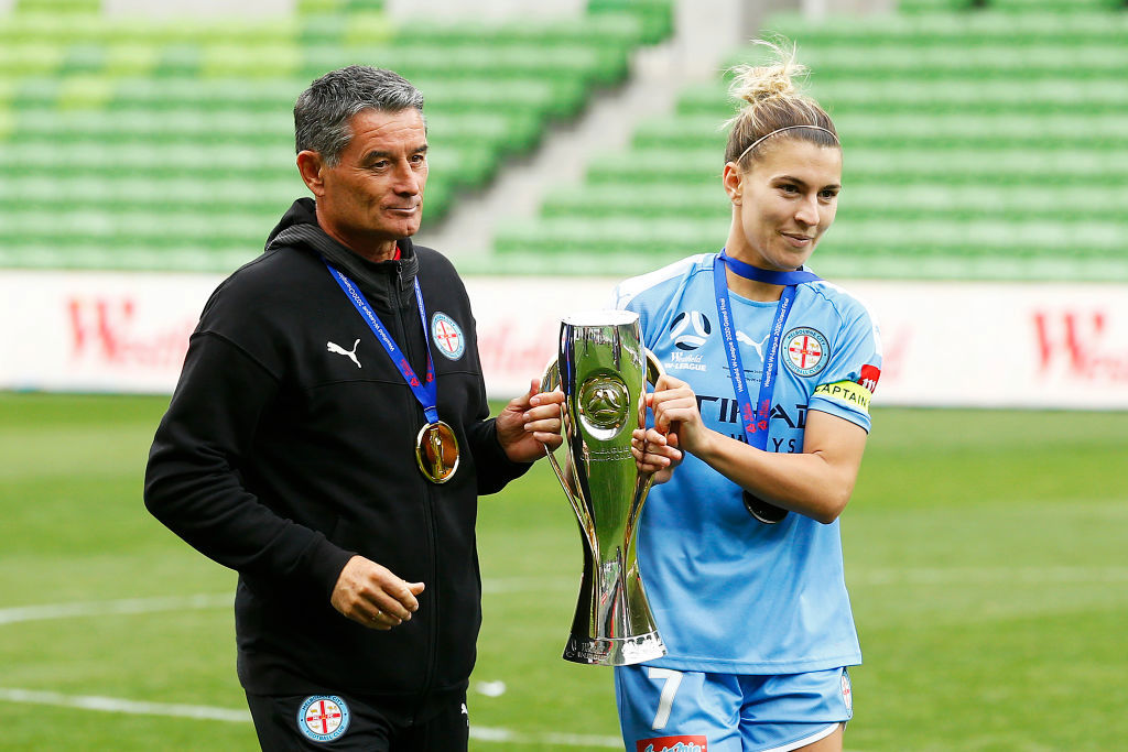 Steph Catley and coach Rado Vidosic of Melbourne City carry the A-League Women's premiership trophy.