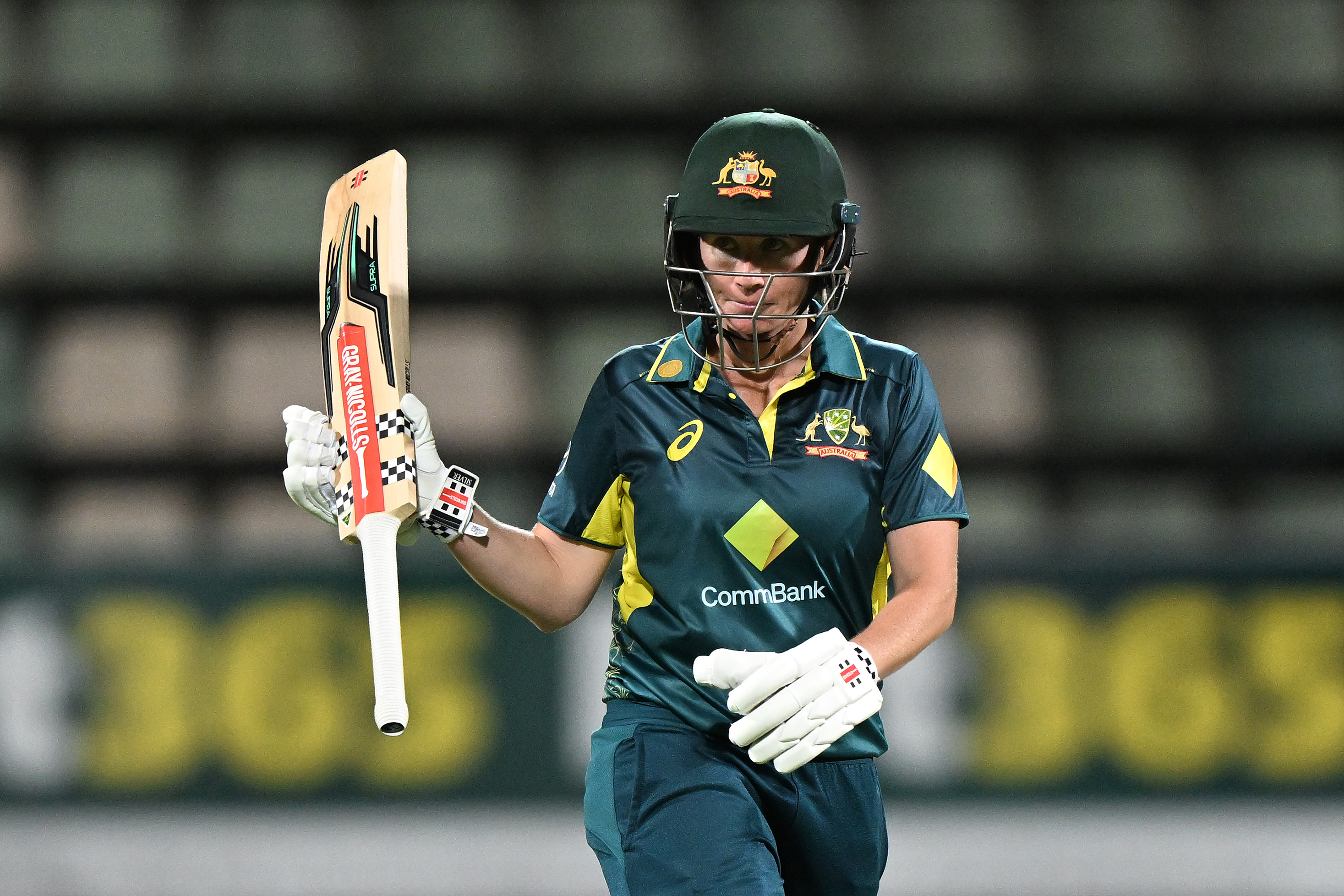 Beth Mooney celebrates scoring a half-century during game three of the women's T20I series between Australia and South Africa at Blundstone Arena.