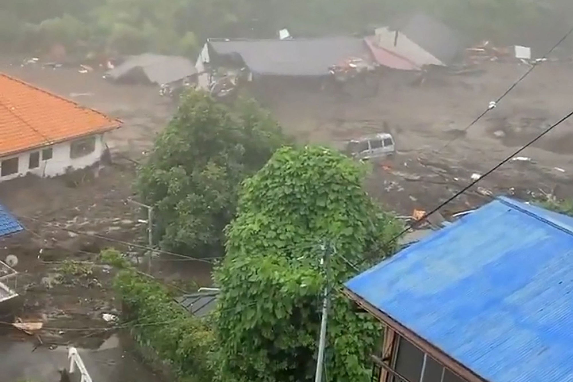 This grab taken from handout video released by a local resident and received via Jiji Press on July 3, 2021 shows mud and debris at the scene of a landslide.