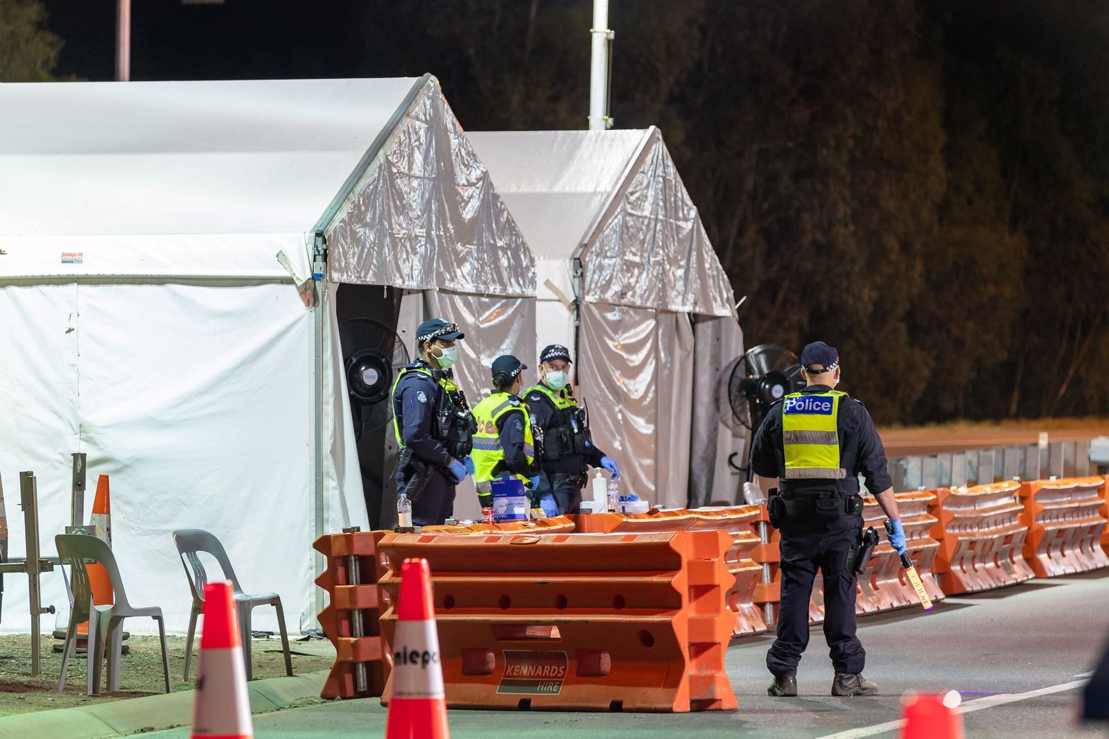 Police patrol at the Albury Border Closure checkpoint at midnight on Saturday 2nd January 2020. Victoria closed its border to NSW again in the wake of another coronavirus COVID- 19 outbreak. 