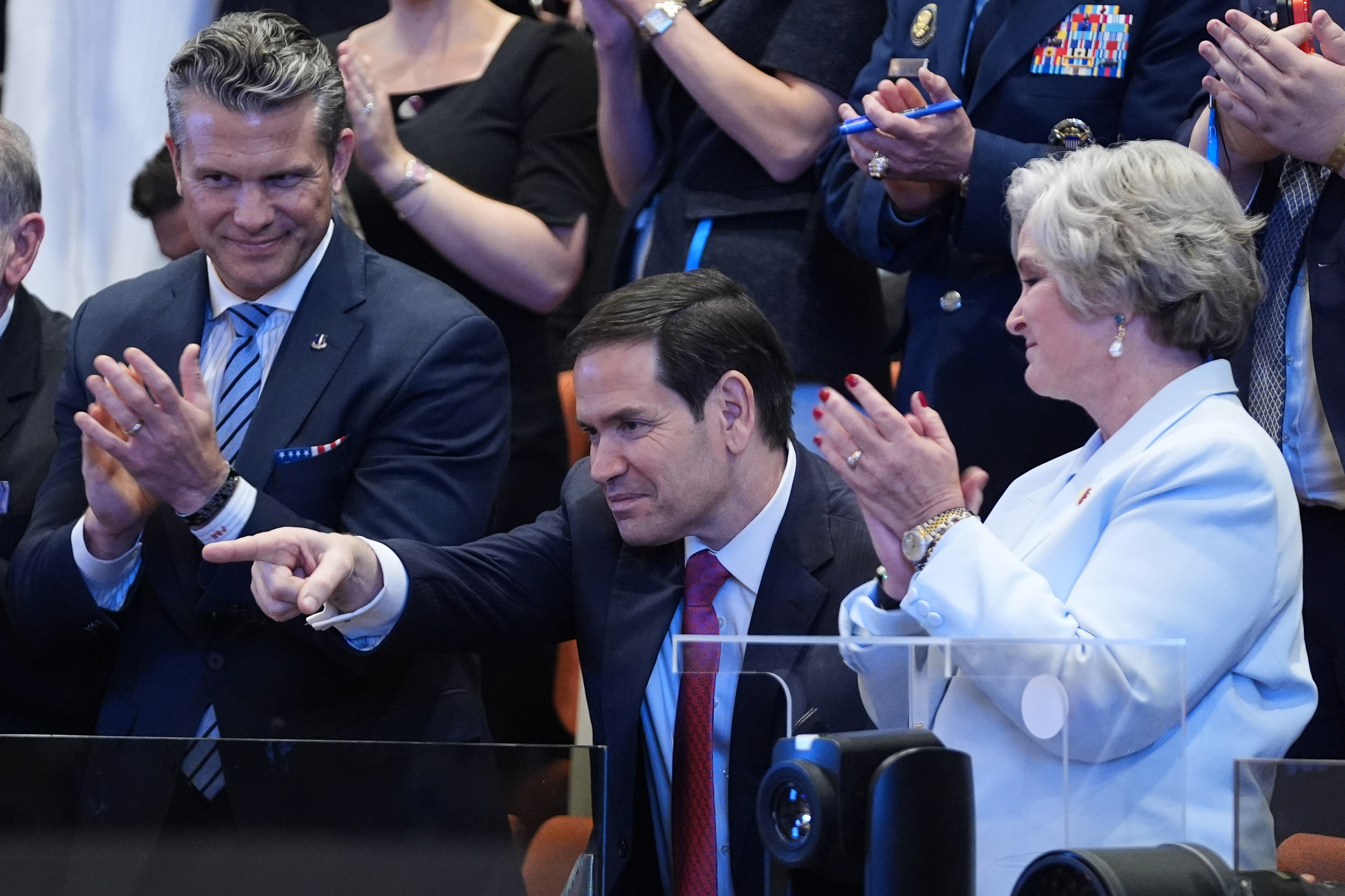 Secretary of State Marco Rubio is recognized by President Donald Trump as he speaks to the Knesset, Israel's parliament, Monday, Oct. 13, 2025, in Jerusalem, as Defense Secretary Pete Hegseth and White House chief of staff Susie Wiles watch. (AP Photo/Evan Vucci, Pool)