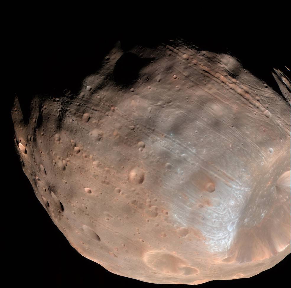 New modeling indicates that the grooves on Mars' moon Phobos could be produced by tidal forces – the mutual gravitational pull of the planet and the moon. Initially, scientists had thought the grooves were created by the massive impact that made Stickney crater (lower right). Image Credit: NASA/JPL-Caltech/University of Arizona