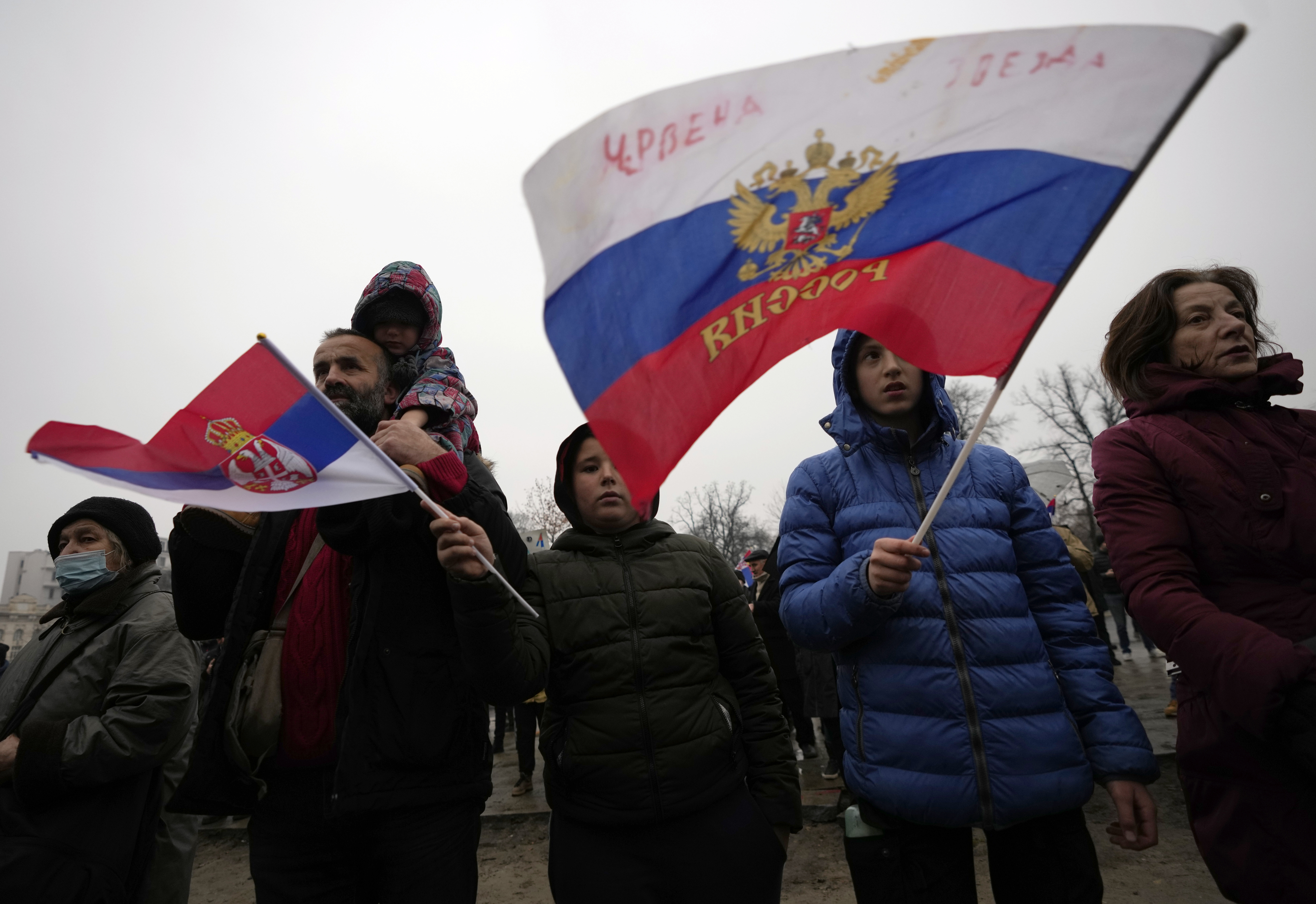 Supporters of Serbia's Novak Djokovic wave a Russian, right, and Serbian flags during a protest in Belgrade, Serbia, Saturday, Jan. 8, 2022.