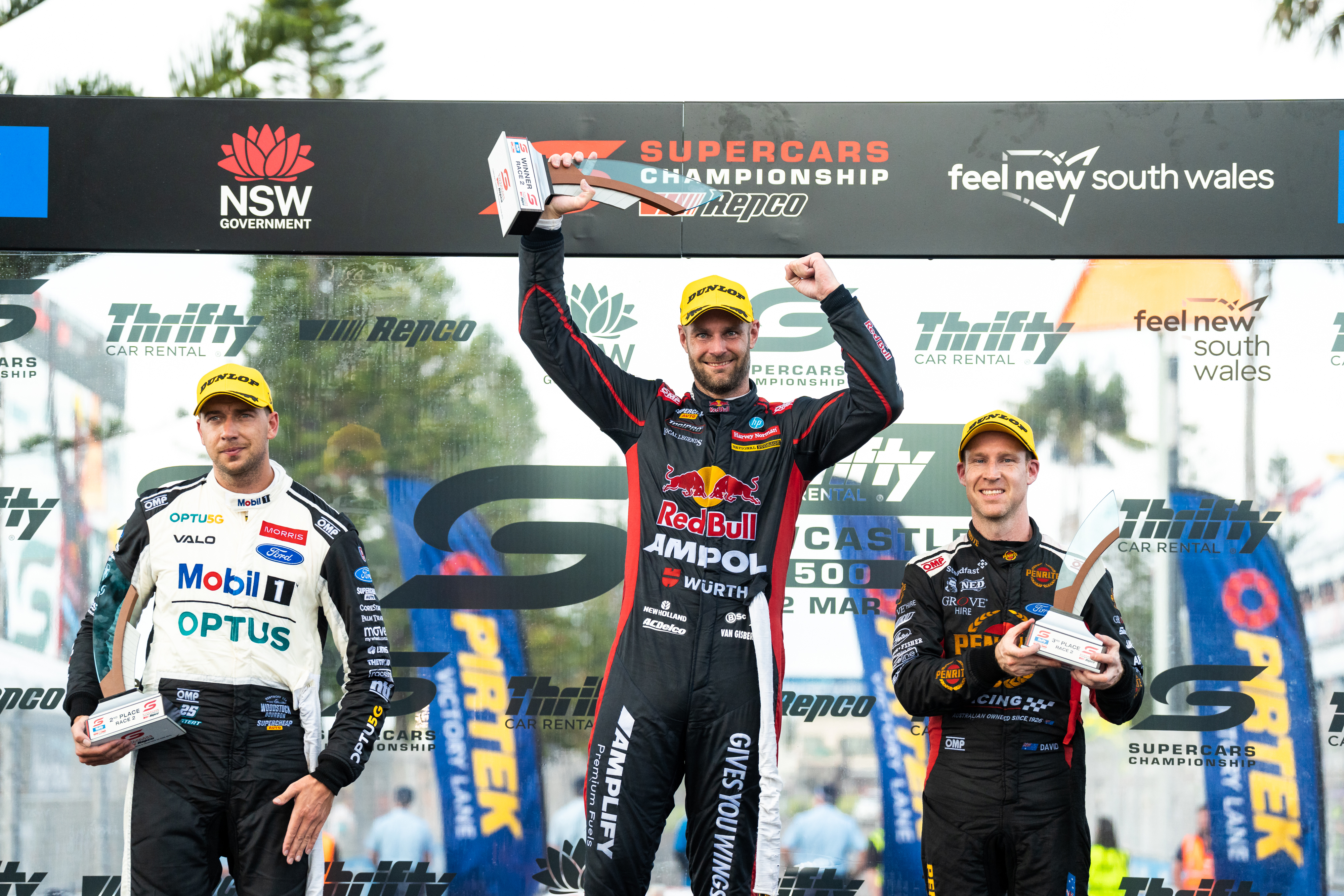 Shane van Gisbergen (middle) celebrates his race two win with Chaz Mostert (left) and David Reynolds (right). 