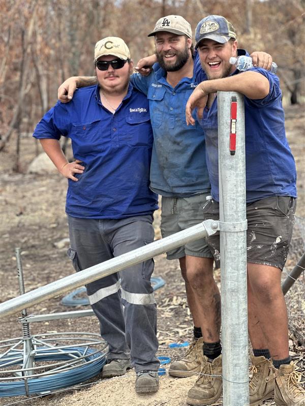 Brady Morris with two younger BackTrack participants at a disaster recovery job in 2025.