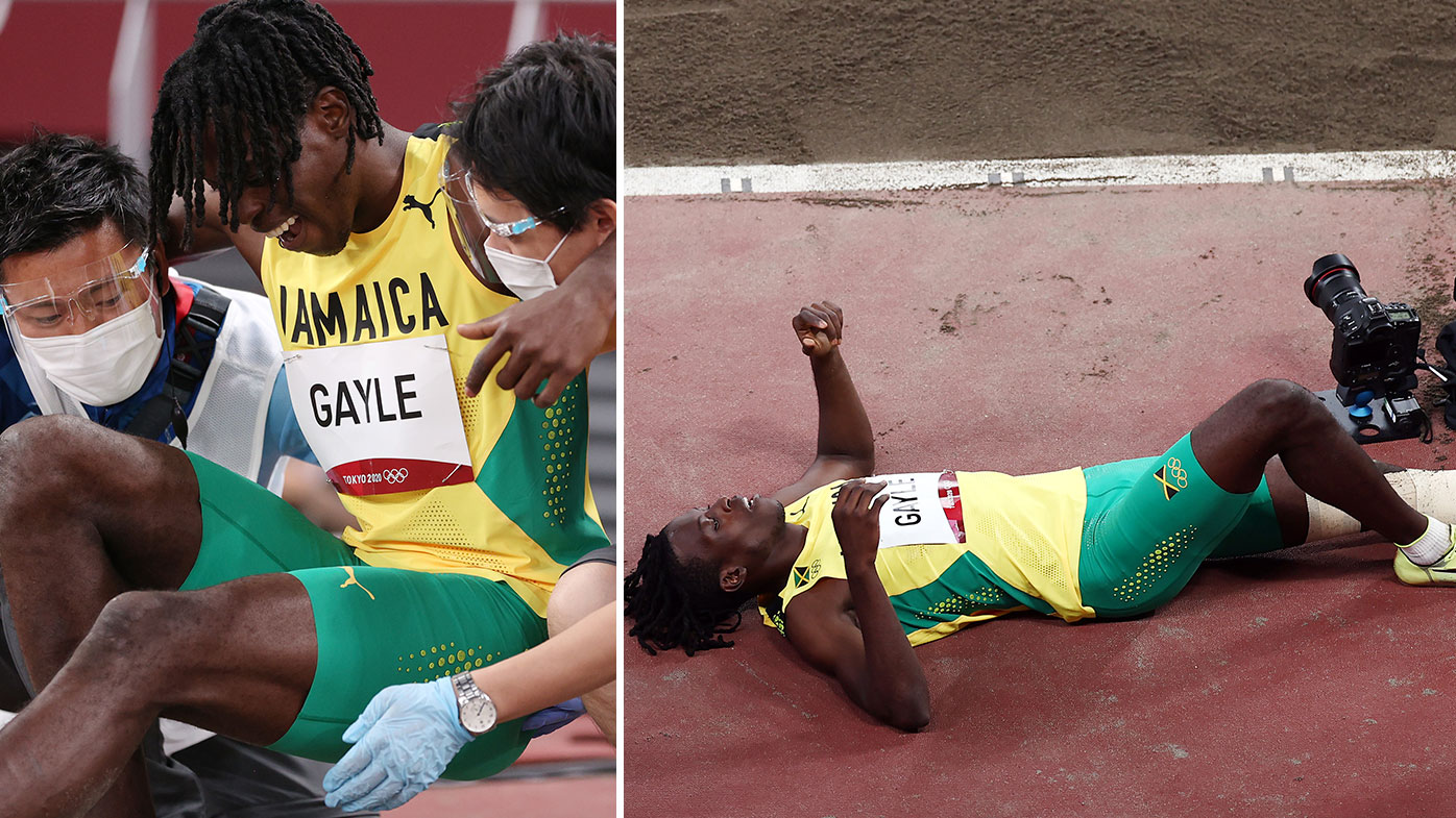 Tajay Gayle of Team Jamaica is helped off after being injured while competing in the Men's Long Jump Qualification on day eight of the Tokyo 2020 Olympic Games at Olympic Stadium on July 31, 2021 in Tokyo, Japan. (Photo by Patrick Smith/Getty Images)