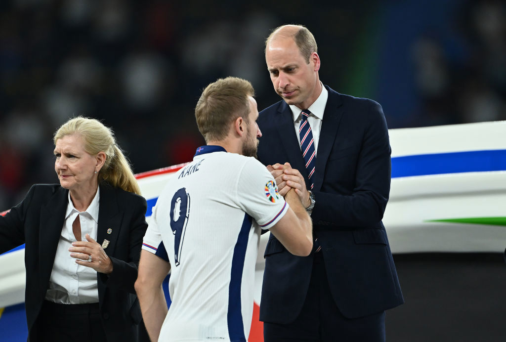 Harry Kane shakes hands with Prince William, Prince of Wales and President of The FA, as he collects his Runners Up Medal.