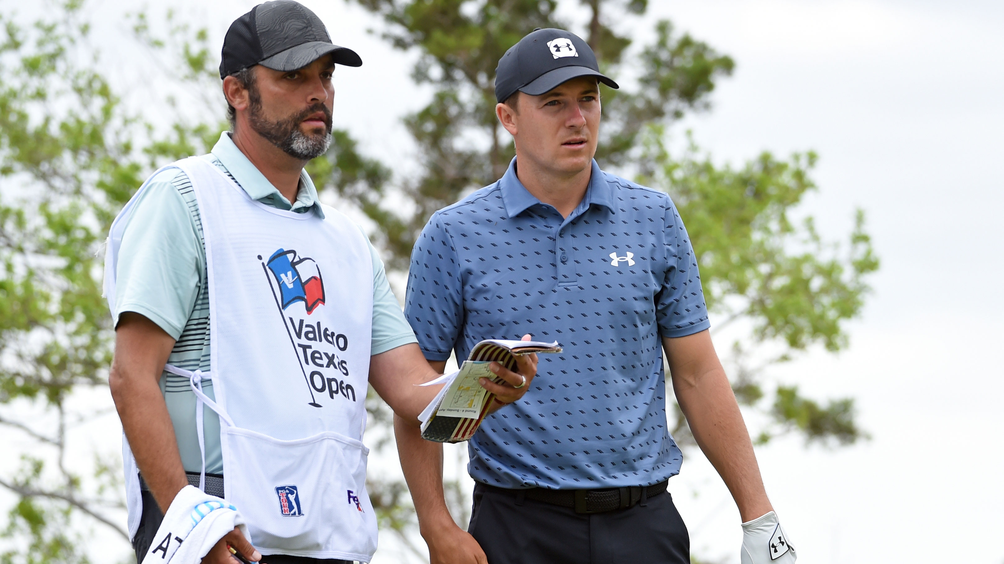Jordan Spieth consults his caddie during the final round of the Texas Open.