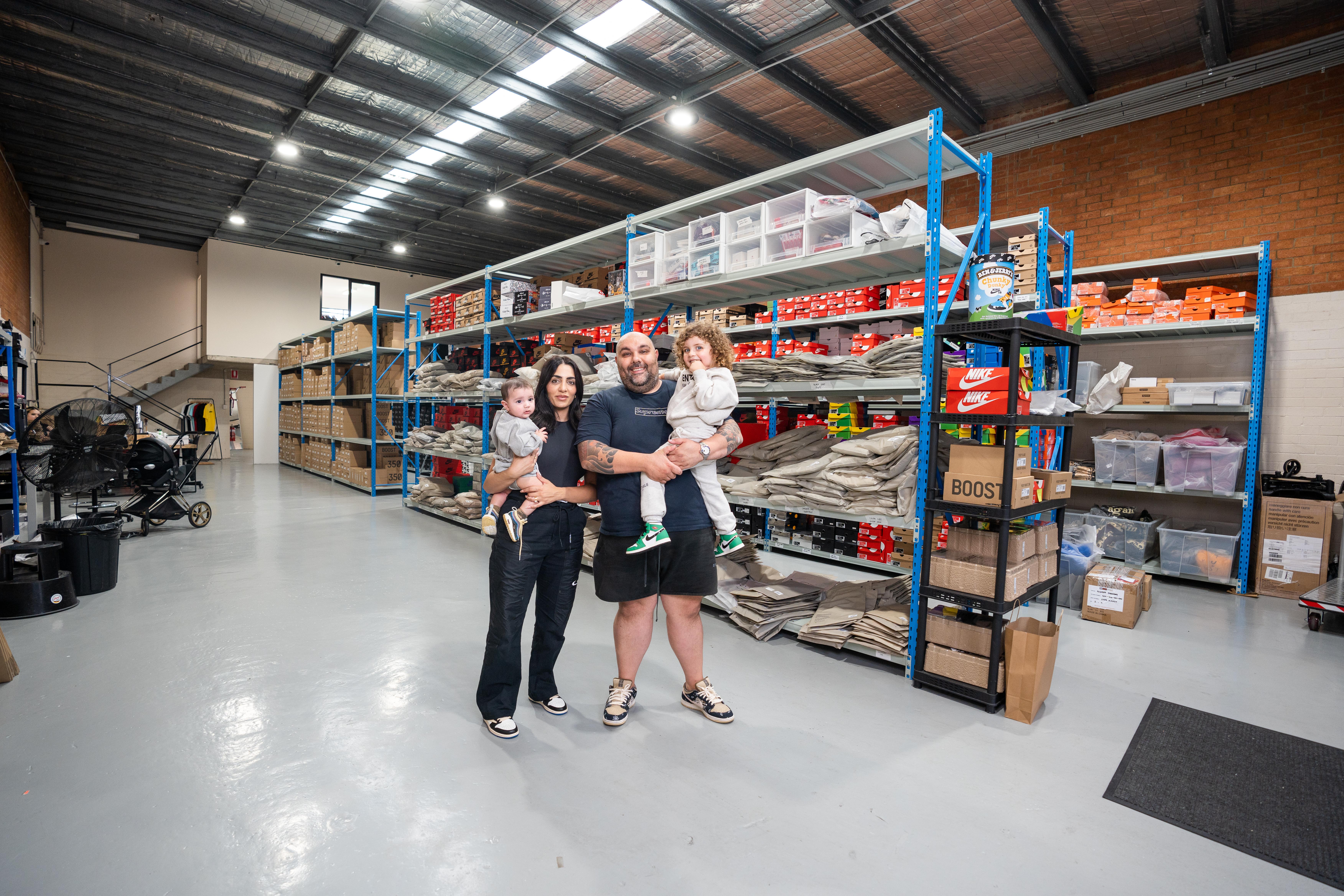 The Kozma family pose together inside one of the Waves Never Die warehouses.