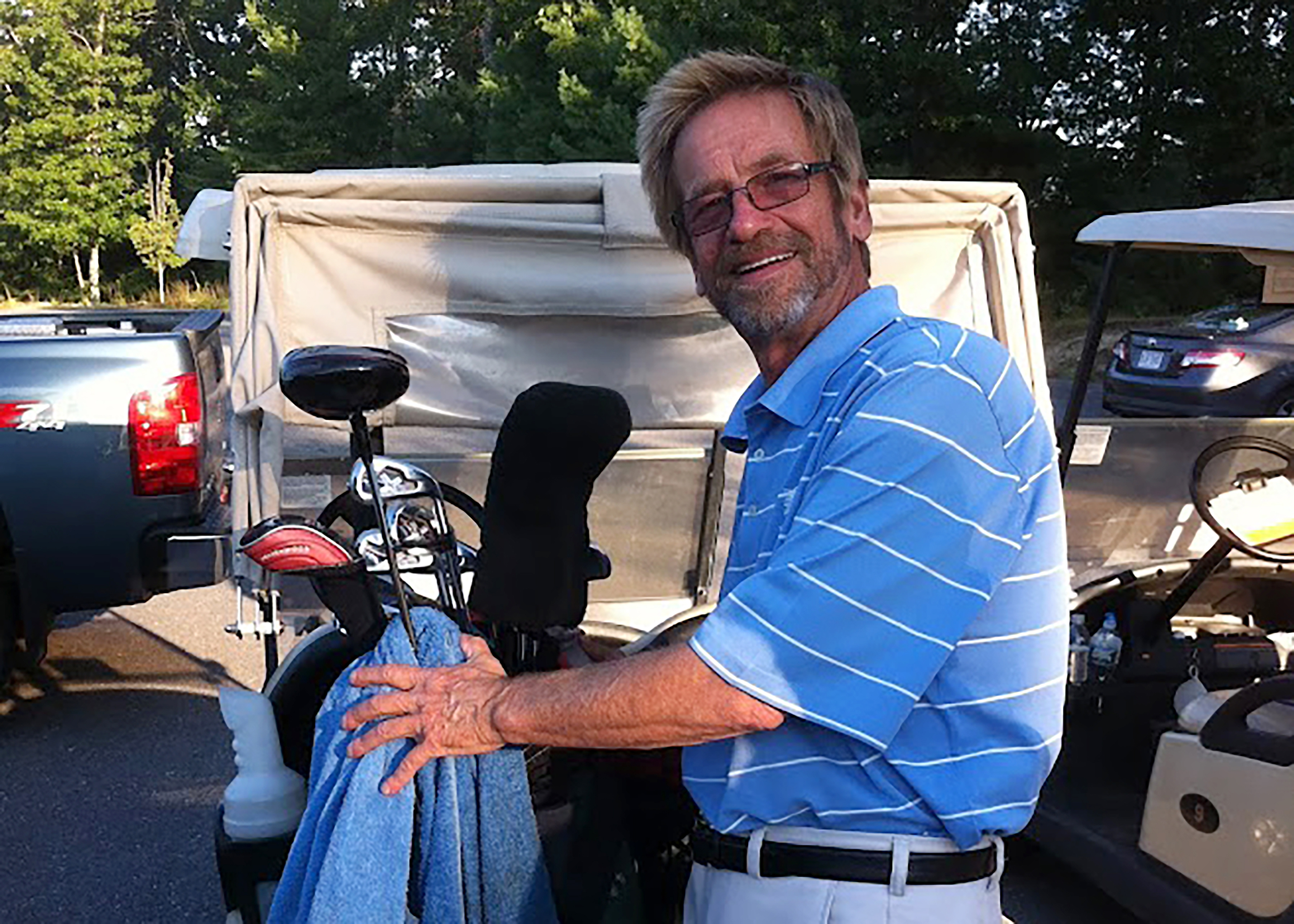 Tom Randele, whose real name according to authorities is Ted Conrad, tends to golf clubs, in September of 2012. 