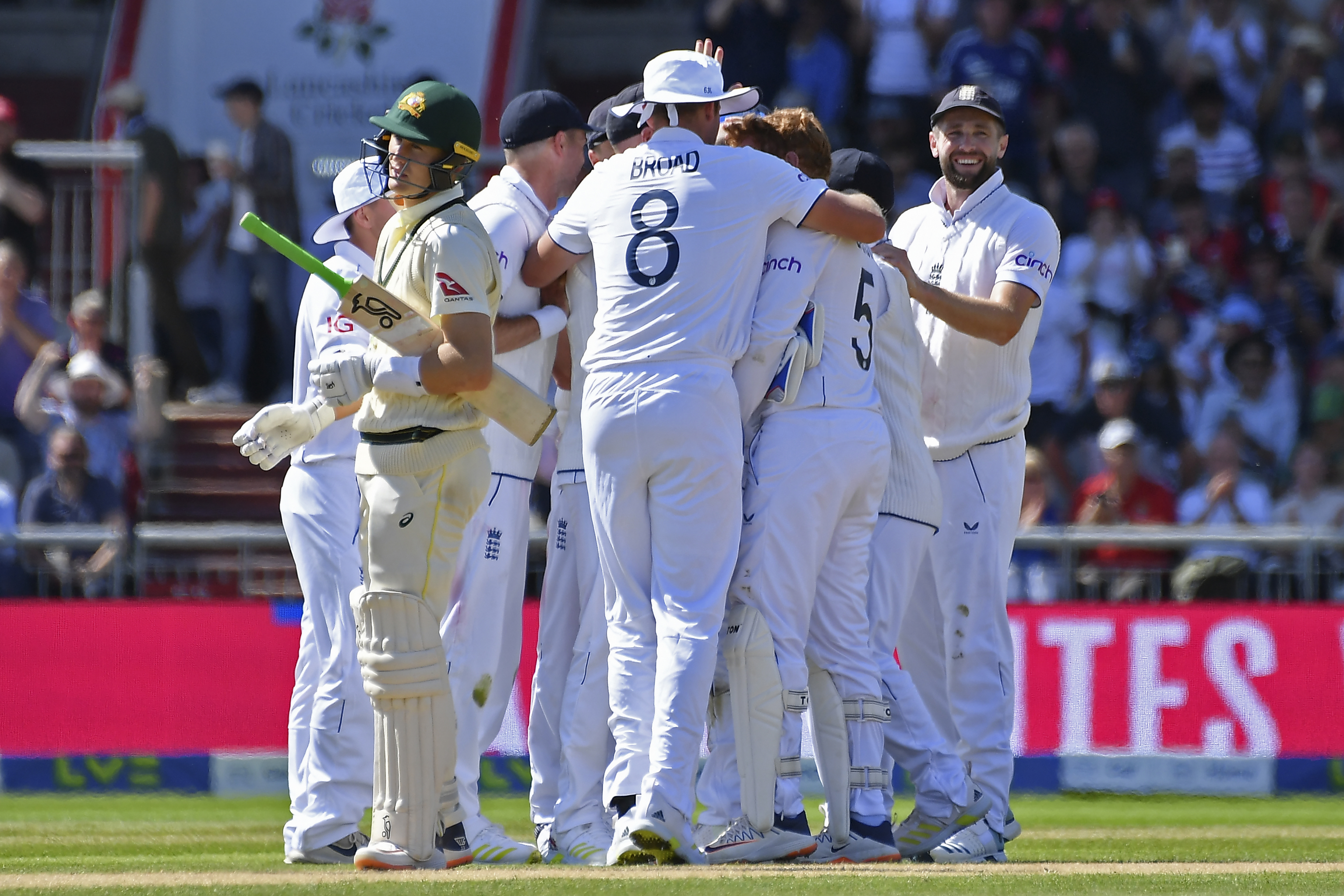 Australia's Marnus Labuschagne reacts as England players celebrate his dismissal.