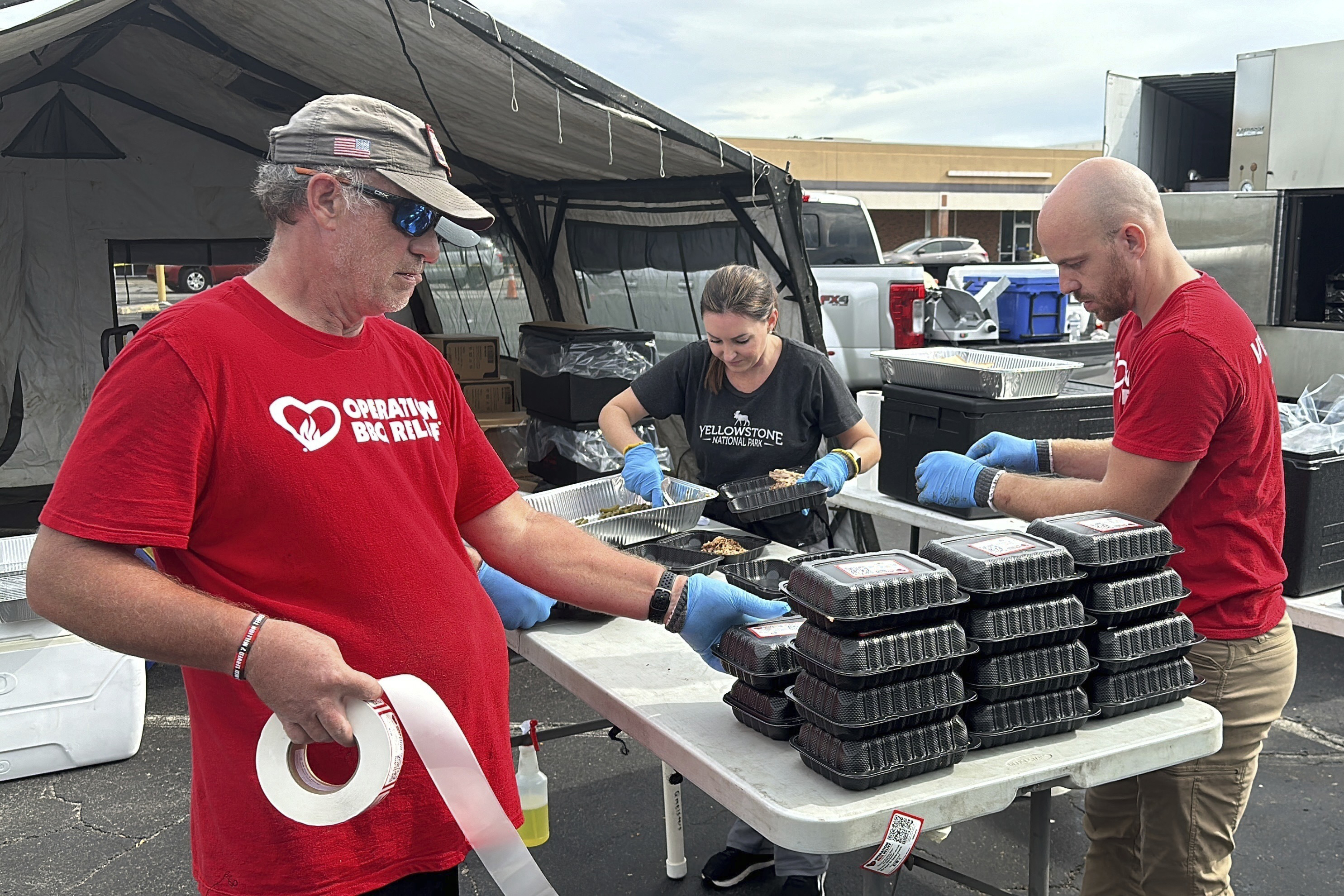 Volunteers for Operation BBQ Relief prepare meals for people without power or water, Oct. 1, 2024, in Augusta, Georgia. (AP Photo / Jeffrey Collins)