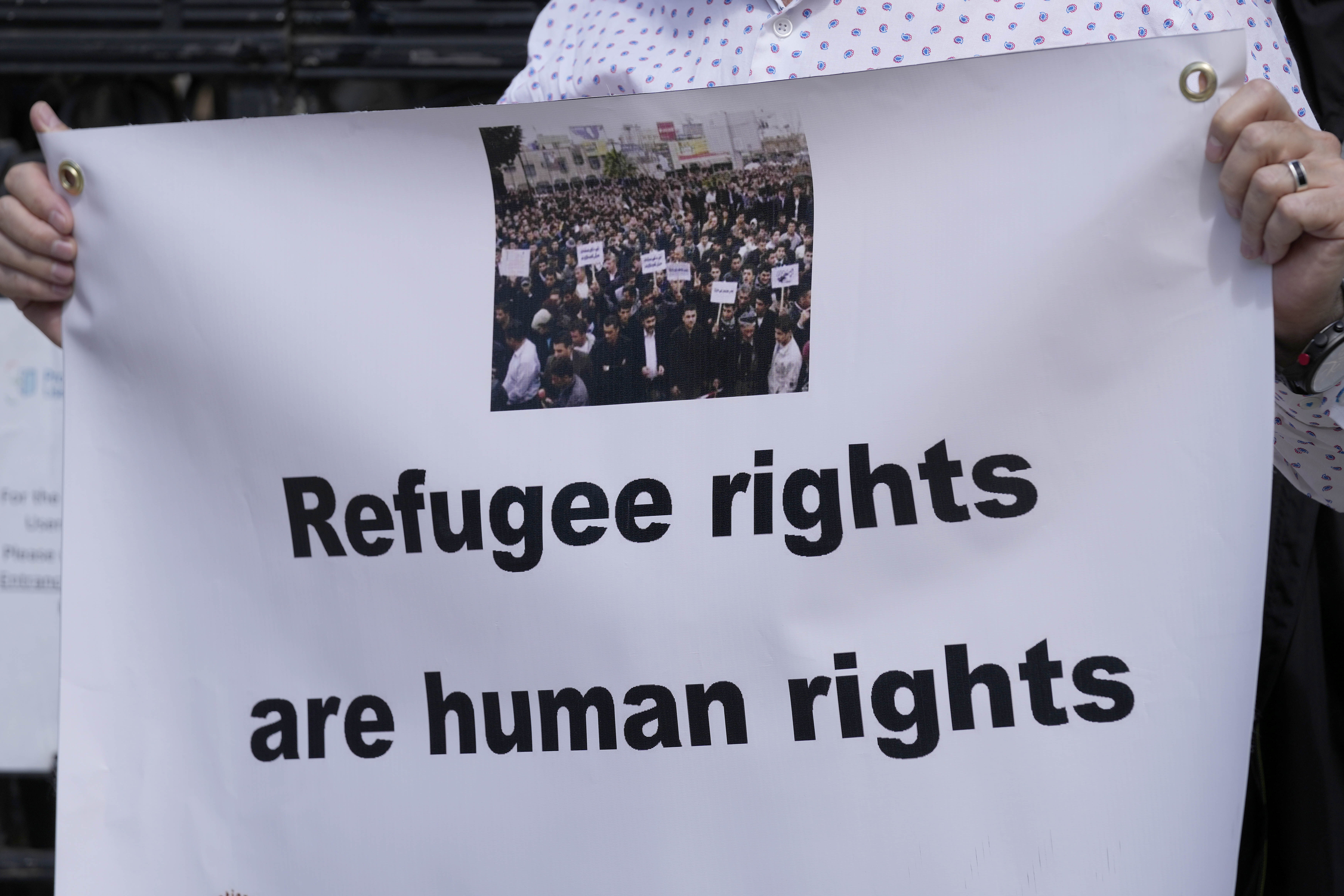 Protestors stand outside The Royal Court of Justice in London, Friday, June 10, 2022. The High Court will hear a legal challenge lodged by Care4Calais, the Public and Commercial Services Union (PCS) and Detention Action, opposing the Home Office's new asylum deal with Rwanda. The case alleges that Priti Patel's proposals are in contravention of international law and the UN refugee convention. (AP Photo/Frank Augstein)