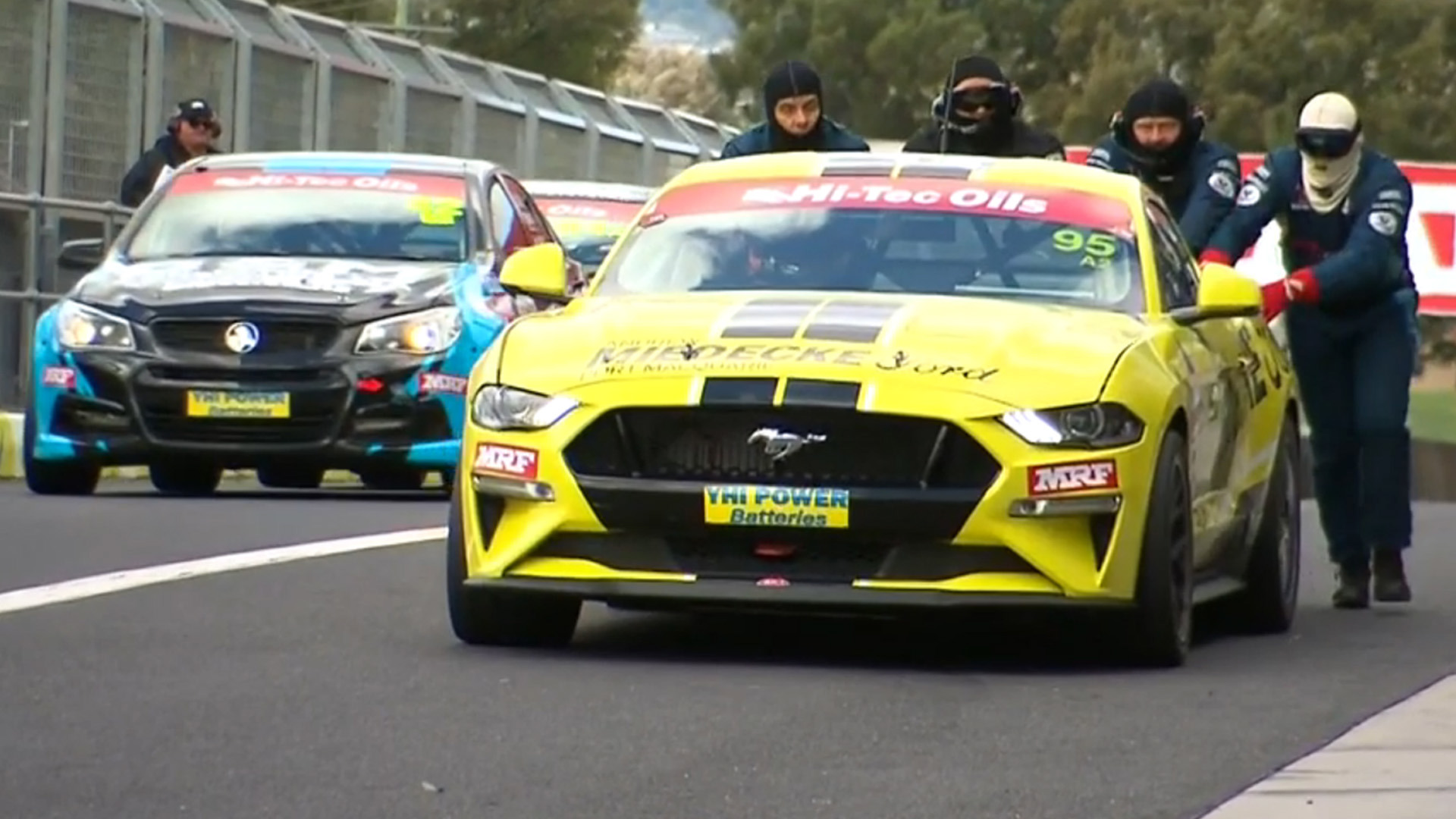 The broken Ford Mustang driven by Marcos Ambrose.