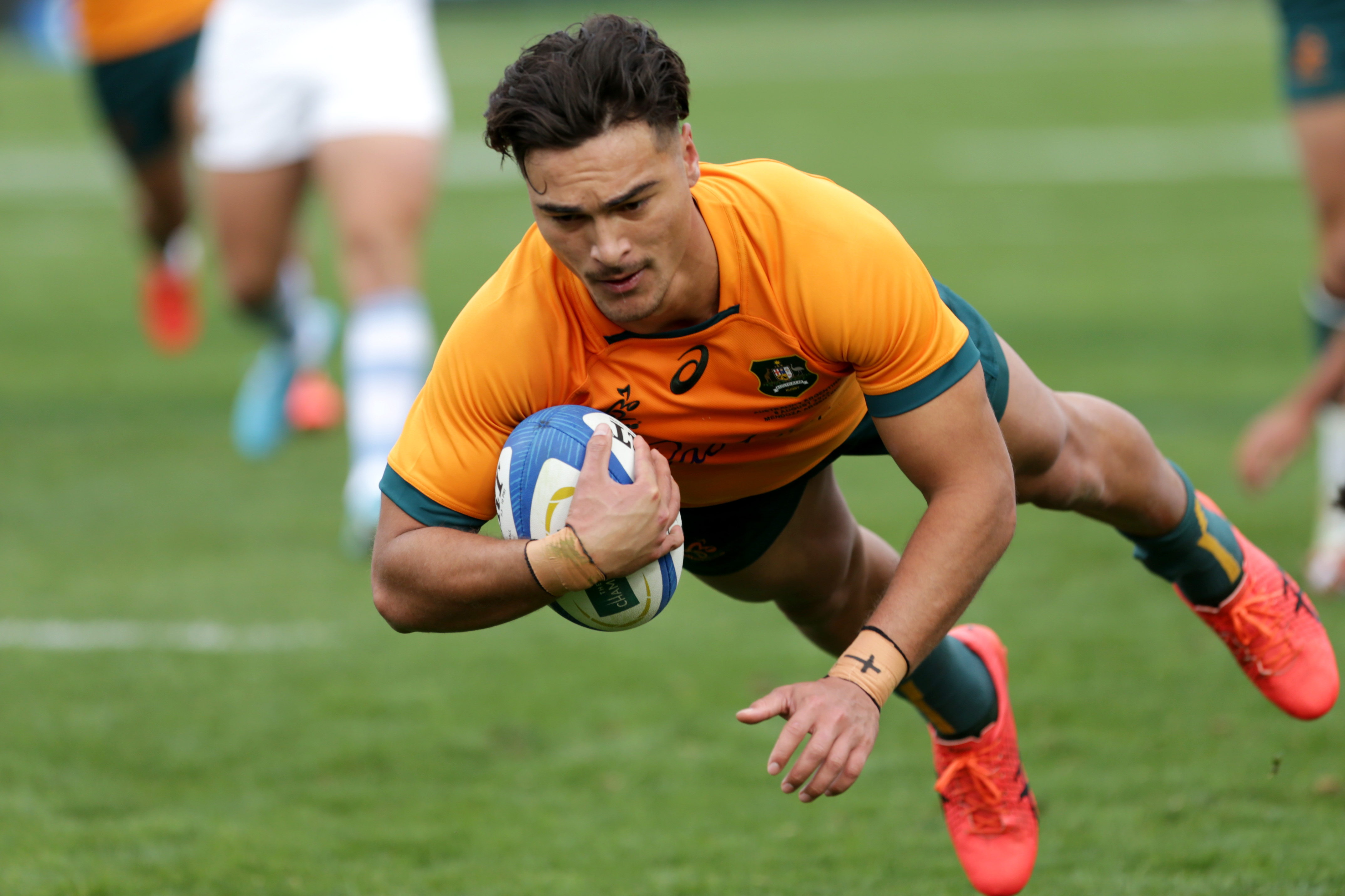 Jordan Petaia of Australia scores a try.