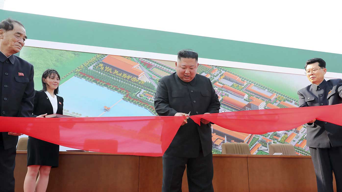Kim Jong-un cuts a ribbon in front of his sister Kim Yo-jong, the presumed heir apparent to the dynasty.