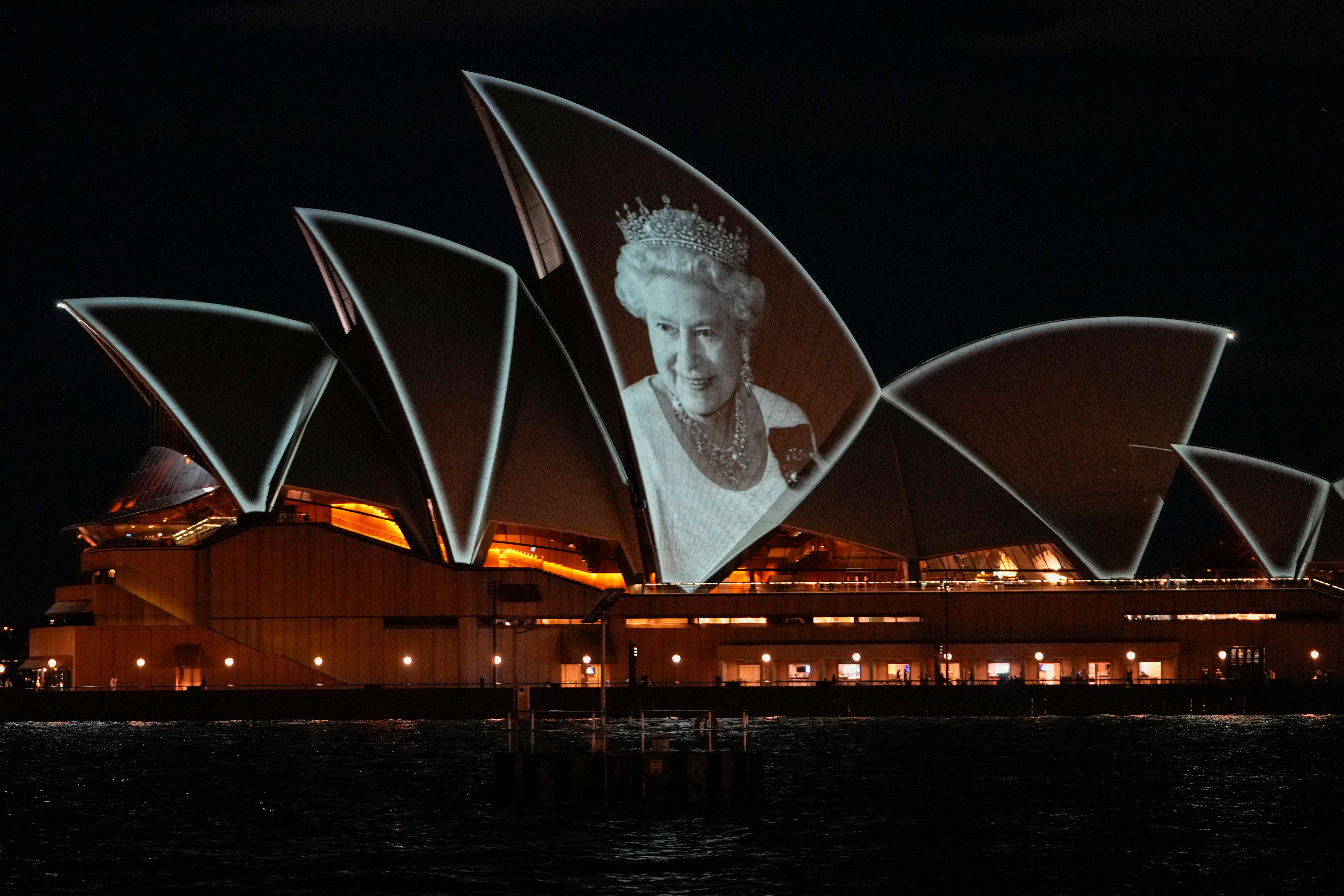 The Sydney Opera House is illuminated with a portrait of Queen Elizabeth II