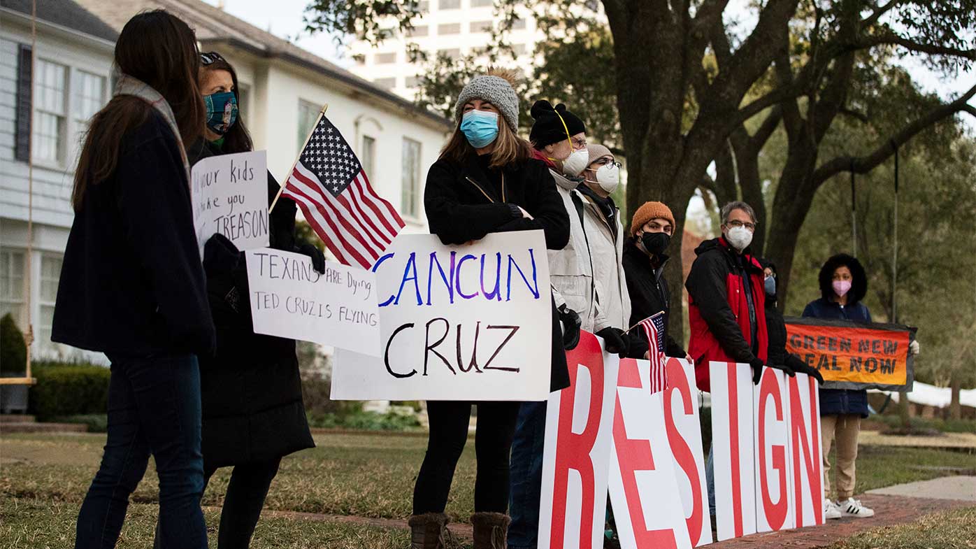 Protesters line the streets outside Ted Cruz's home demanding his resignation.