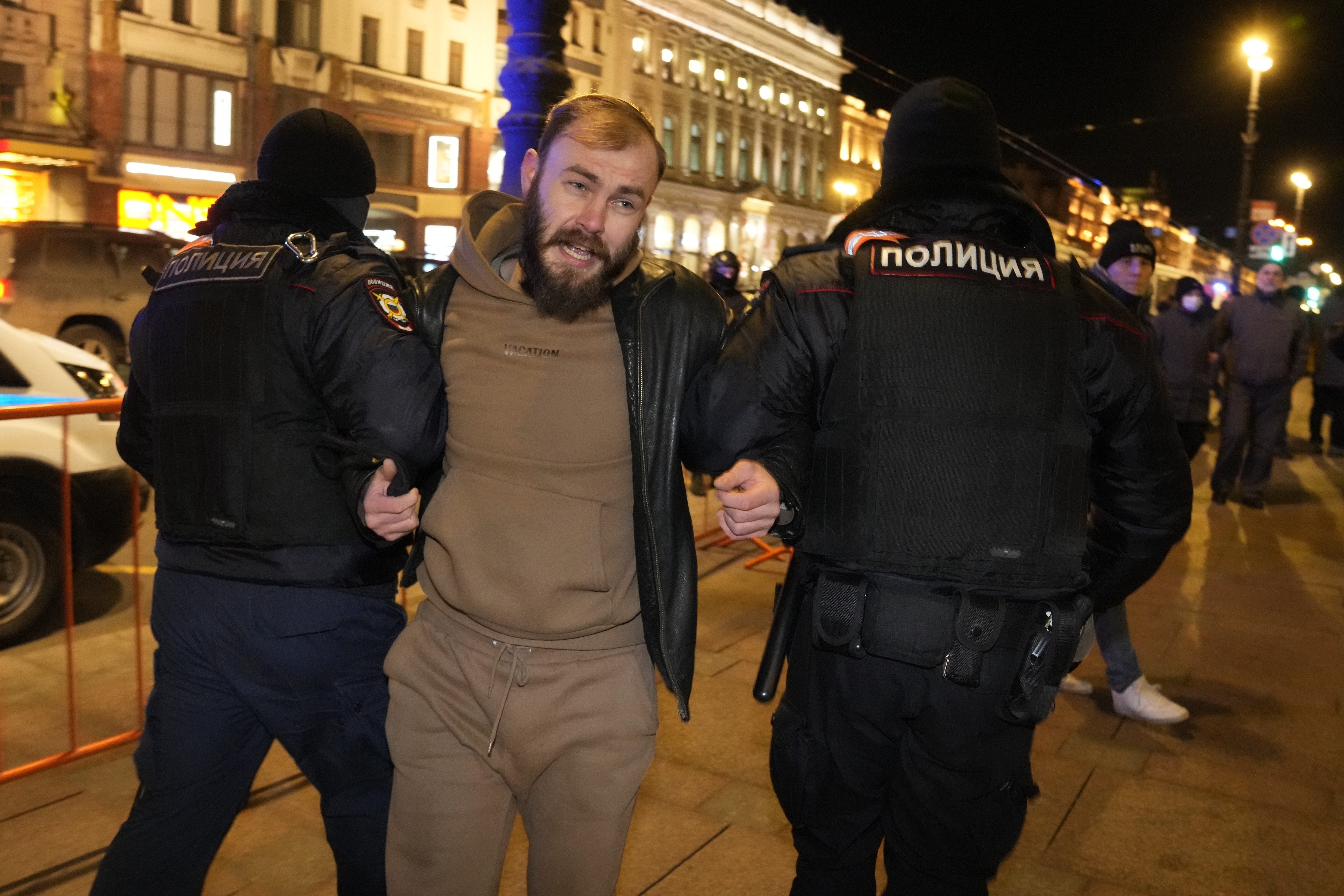 Police detain a demonstrator during an action against Russia's attack on Ukraine in St. Petersburg, Russia, Saturday, Feb. 26, 2022. Protests against the Russian invasion of Ukraine resumed on Saturday evening, with people taking to the streets of Moscow and St. Petersburg for the third straight day despite mass arrests. OVD-Info rights group reported that at least 325 people were detained in 26 Russian cities on Saturday in antiwar protests, nearly half of them in Moscow. (AP Photo/Dmitri Lovet