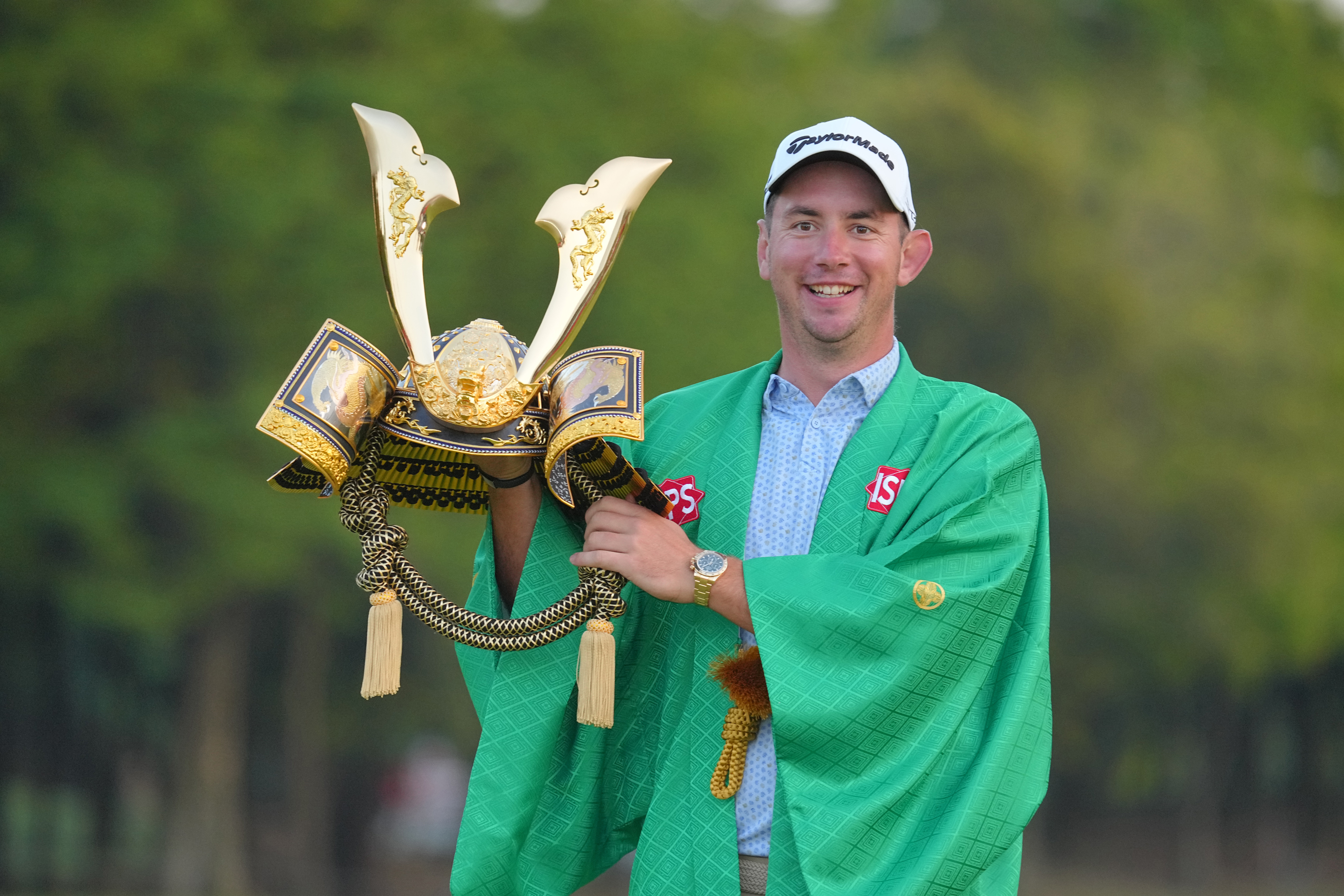 Lucas Herbert of Australia poses with the trophy for winning the ISPS Handa Championship.