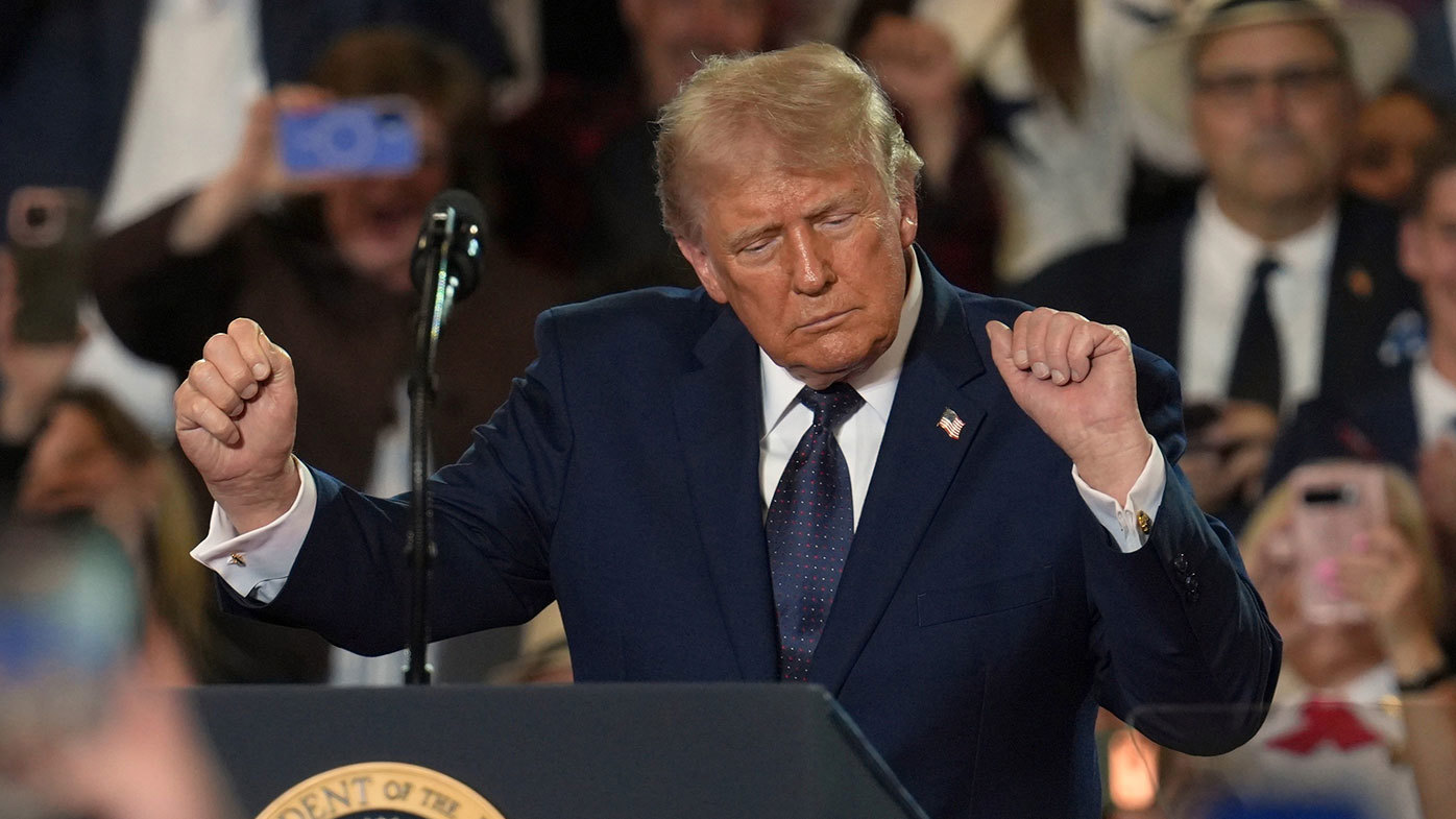 Donald Trump dances at a campaign event in New York today.