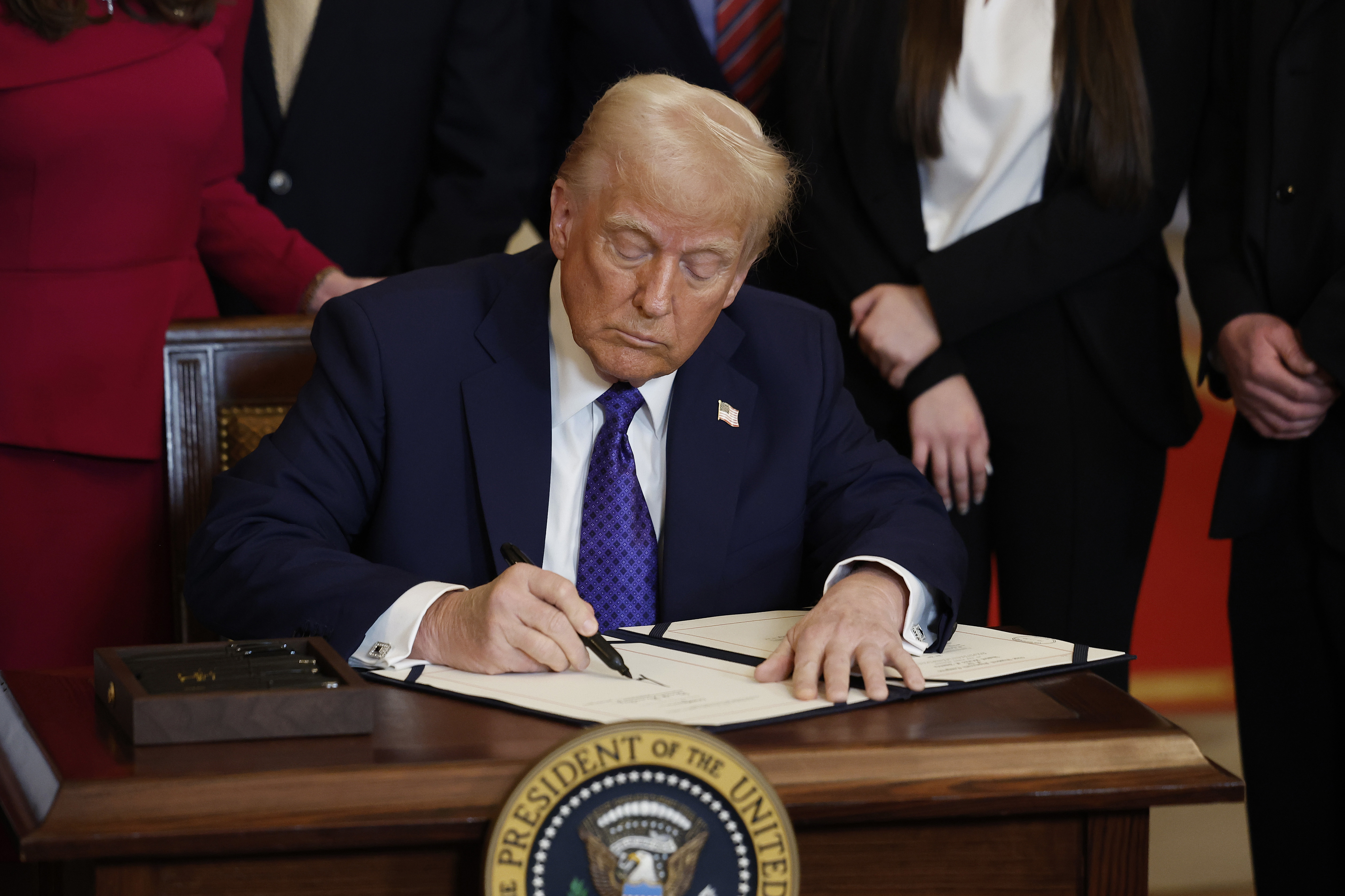 WASHINGTON, DC - JANUARY 29: U.S. President Donald Trump signs the Laken Riley Act, the first piece of legislation passed during his second term in office, in the East Room of the White House on January 29, 2025 in Washington, DC. Jason Riley and Allyson Philips, the parents of 22-year-old Laken Riley, a University of Georgia nursing student who was murdered in 2024 by an undocumented immigrant, attended the signing ceremony. Among other measures, the law directs law enforcement authorities to d