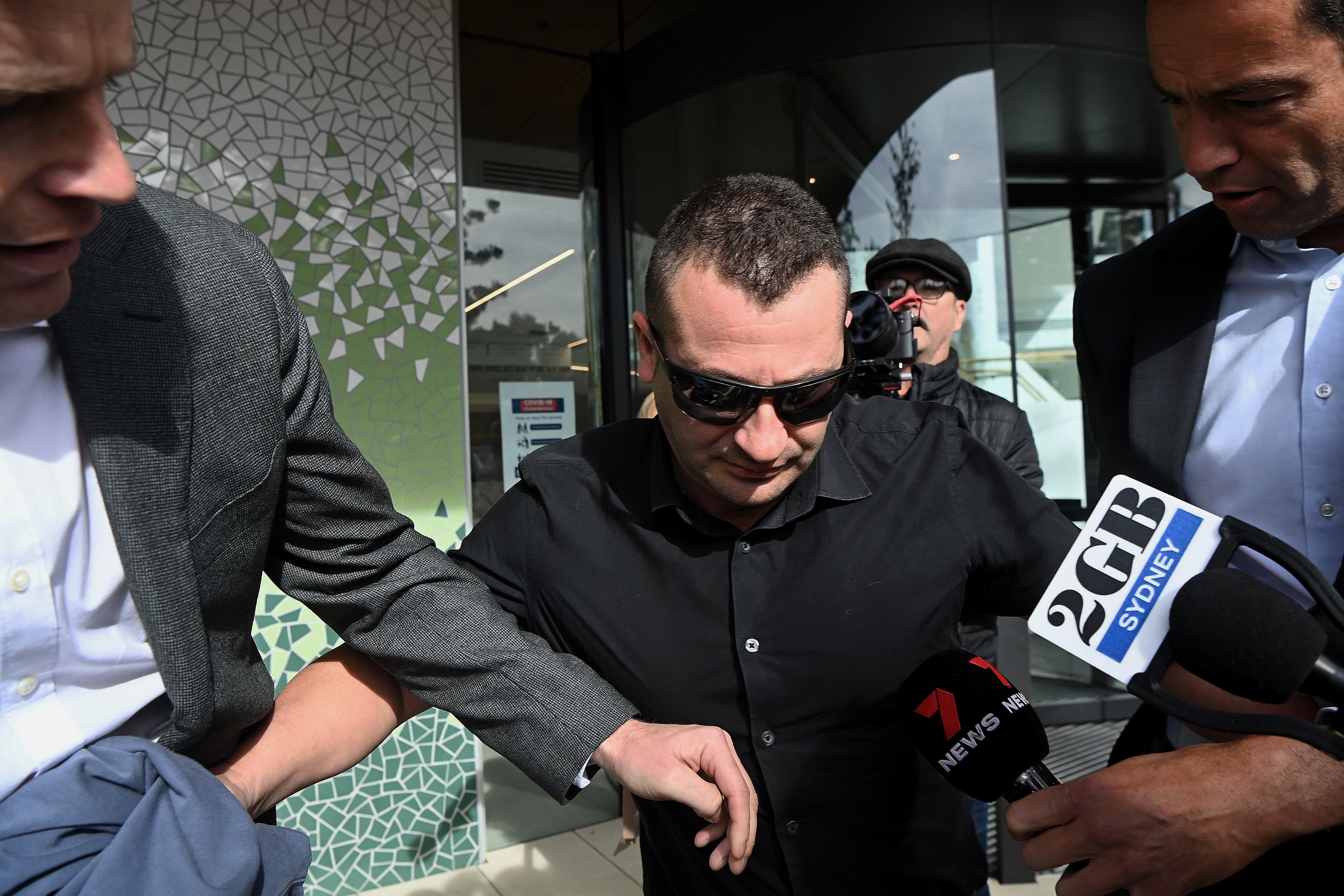 Anthony Koletti (centre) the husband of Melissa Caddick leaves Lidcombe coroners court, NSW.  The coroner described Koletti as an unreliable and unimpressive witness. May 25, 2023. Photo: Kate Geraghty