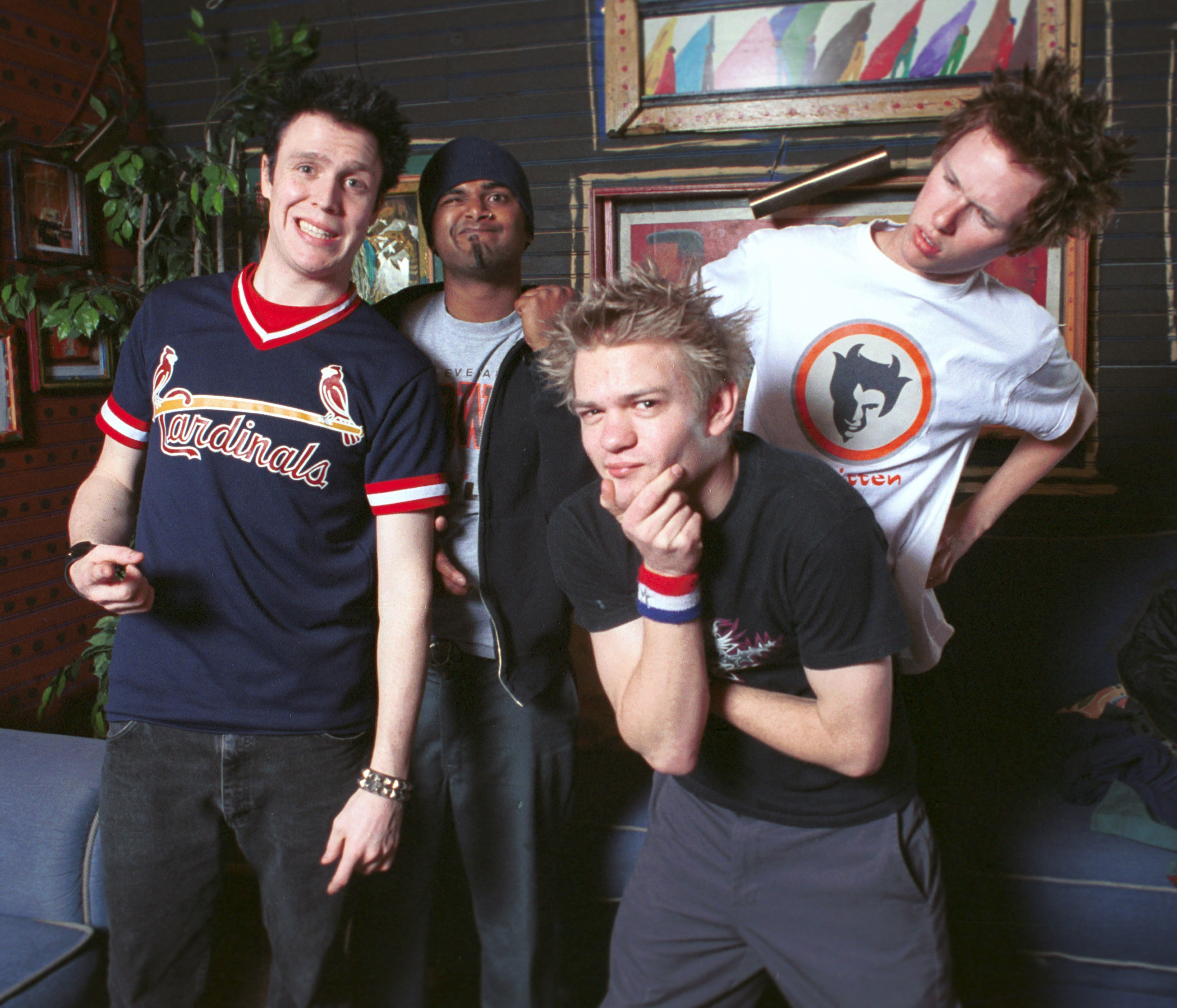 399775 06: (L-R) Sum 41 band members Steve Jocz, Dave Baksh, Deryck Whibley, and Cone McCaslin pose backstage January 18, 2002 before performing at the House of Blues in Las Vegas, NV. The band is currently on tour to promote their new album, "All Killer No Filler." (Photo by Scott Harrison/Getty Images)