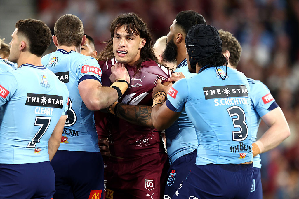  Tino Fa'asuamaleaui of the Maroons is pulled away by NSW Blues players. 