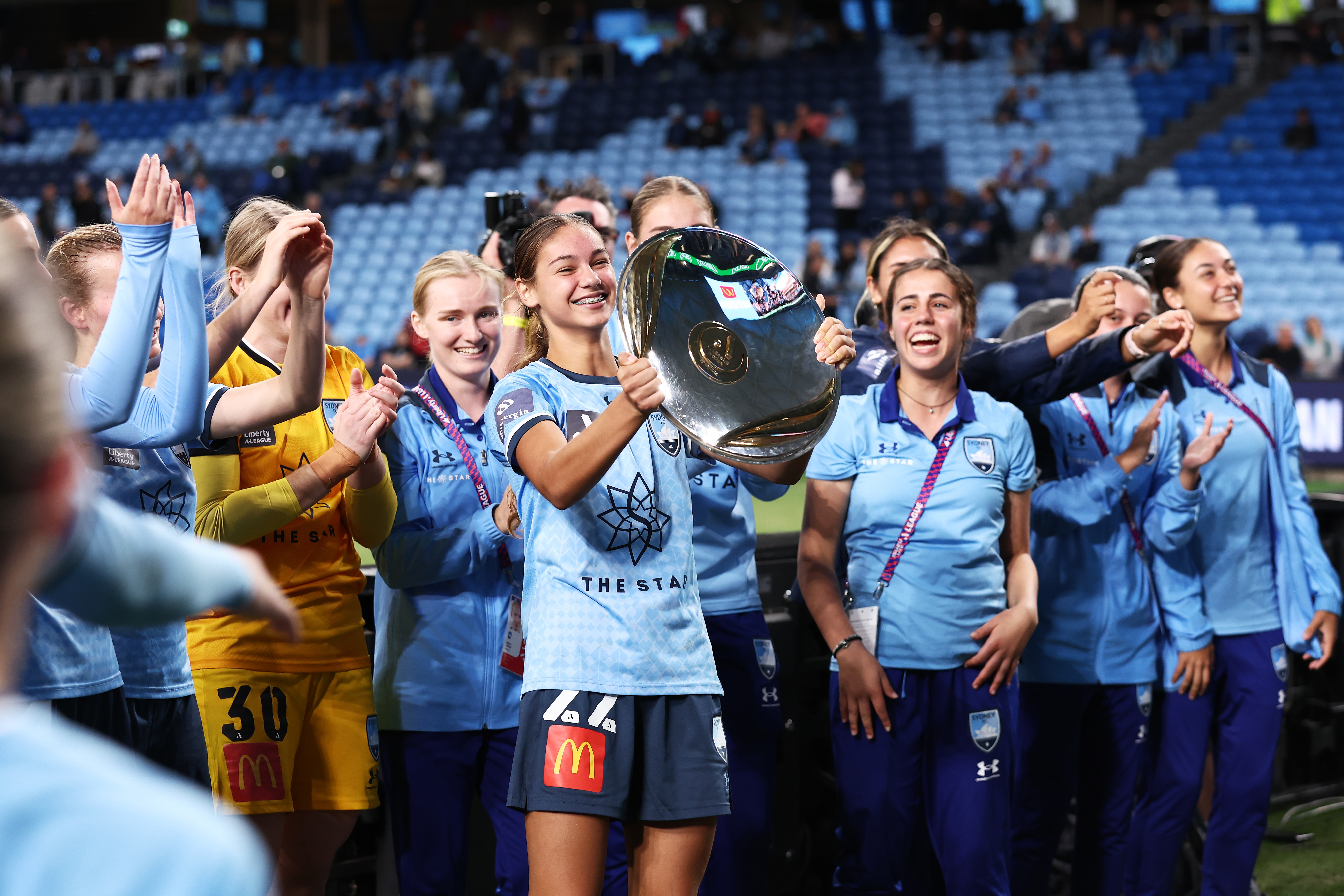 Indiana Dos Santos holds aloft the Premier's Plate after the round 20 A-League Women's match between Sydney FC and the Newcastle Jets.