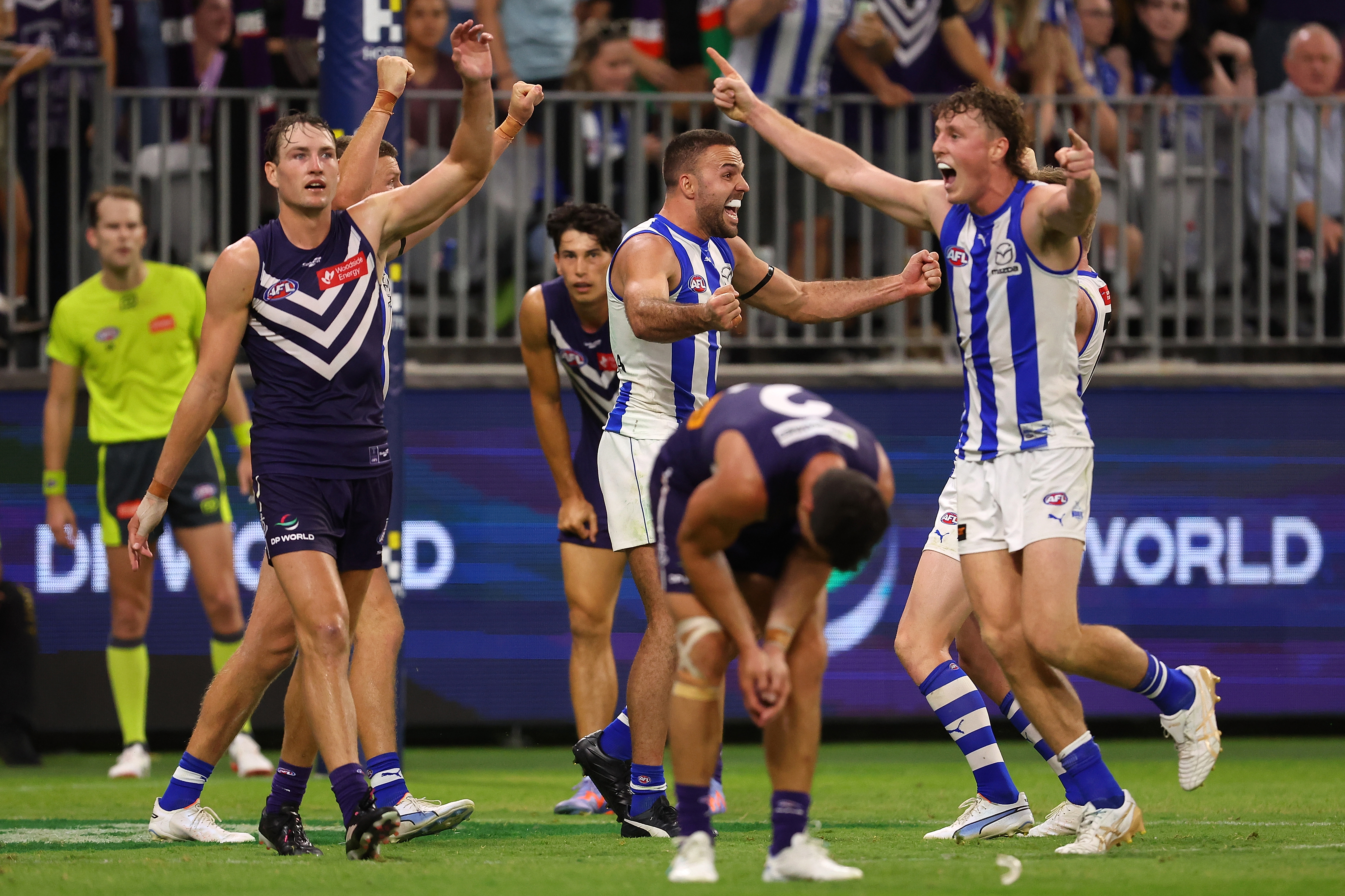 PERTH, AUSTRALIA - MARCH 25: Griffin Logue and Nick Larkey of the Kangaroos celebrate winning the round 2 AFL match between the Fremantle Dockers and North Melbourne Kangaroos at Optus Stadium, on March 25, 2023, in Perth, Australia. (Photo by Paul Kane/Getty Images)