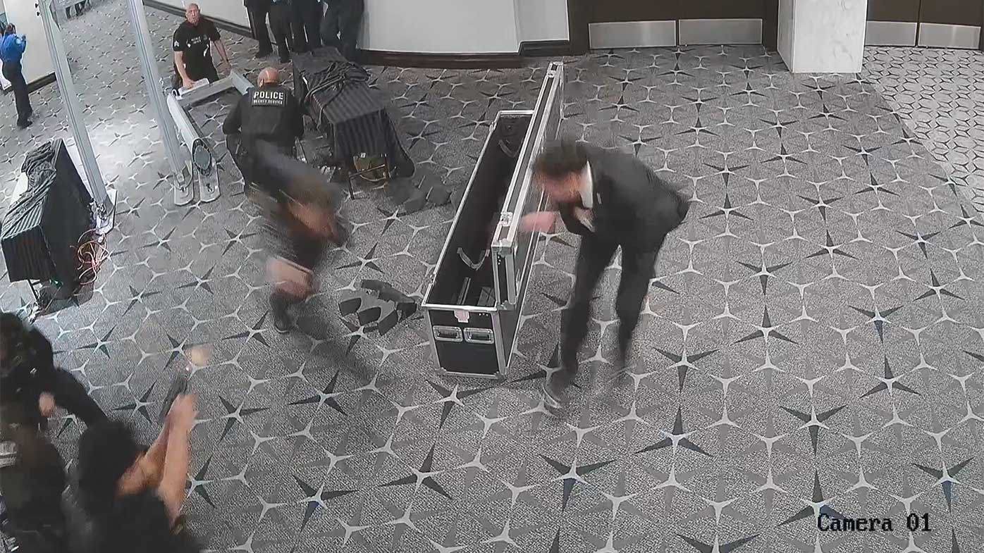 This still shows an officer firing their gun at the suspect.