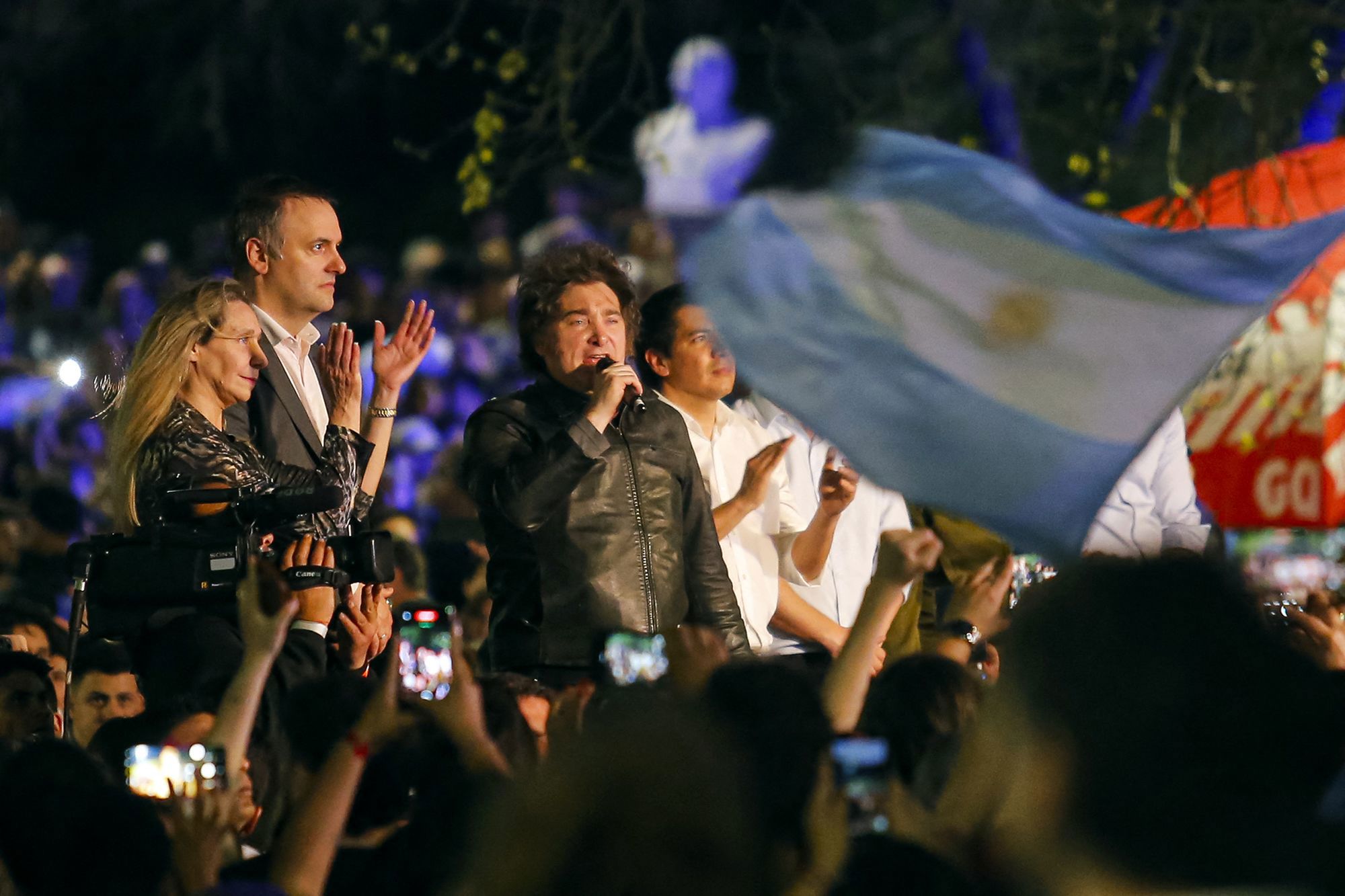 Argentina's President Javier Milei (R) speaks next to legislative candidate Manuel Adorni (C) and Argentina's Secretary General of the Presidency Karina Milei during an open-air political rally at Parque Sarmiento in Cordoba, Argentina on September 19.