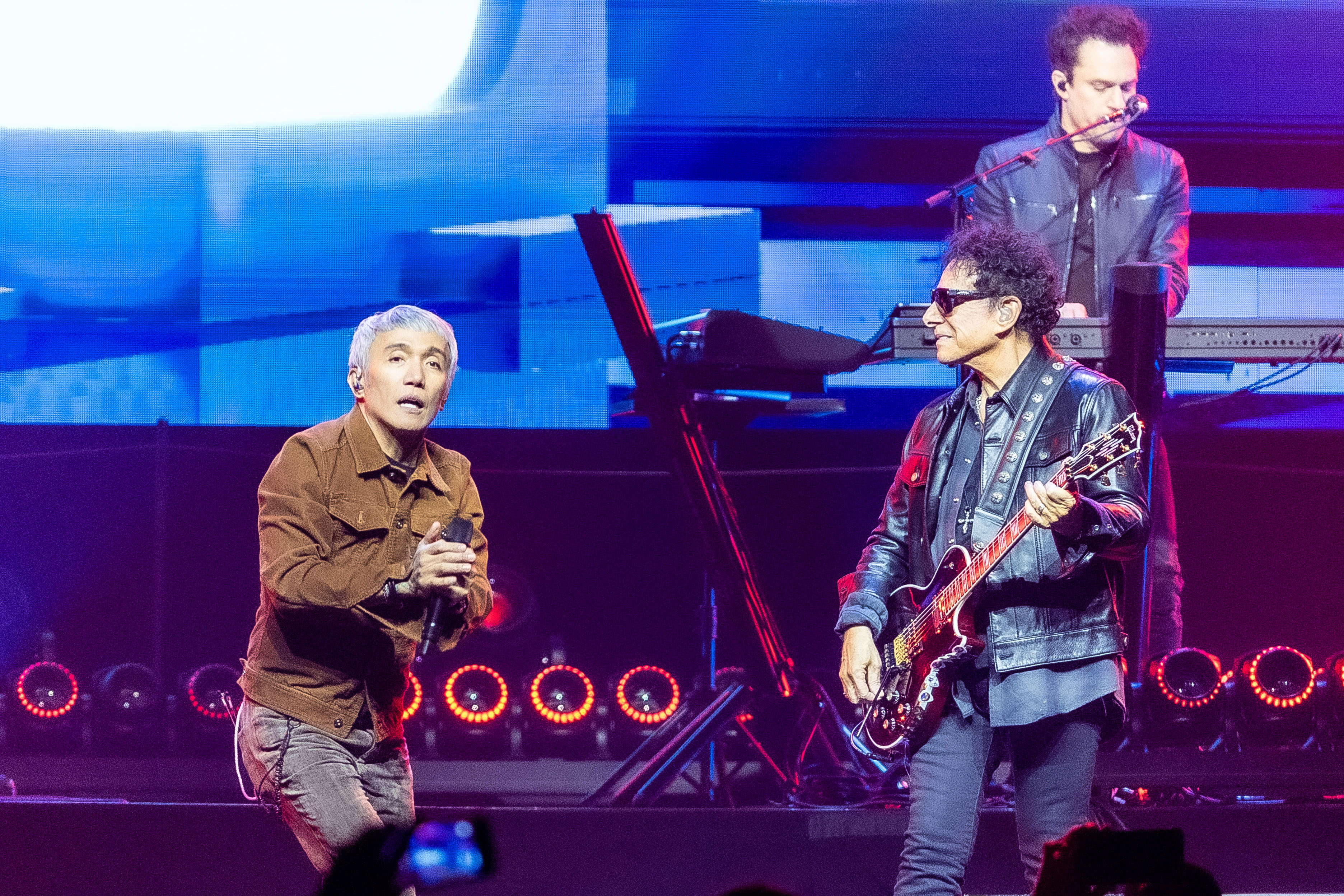 Arnel Pineda (L) and Neal Schon of Journey perform in concert during the 