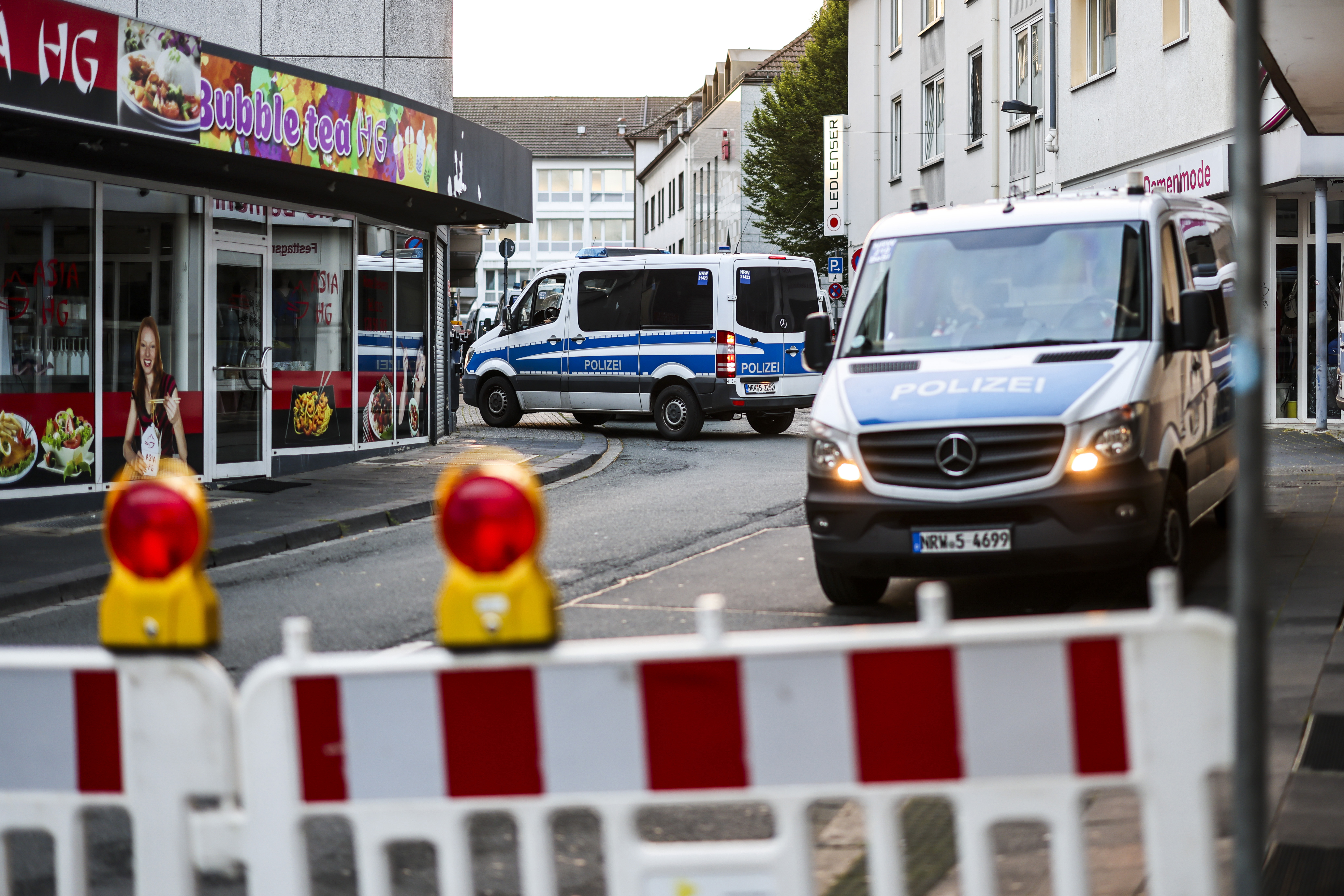 Police cars sit at a cordon early after several people were killed and injured in an attack at the Solingen's 650th anniversary celebrations