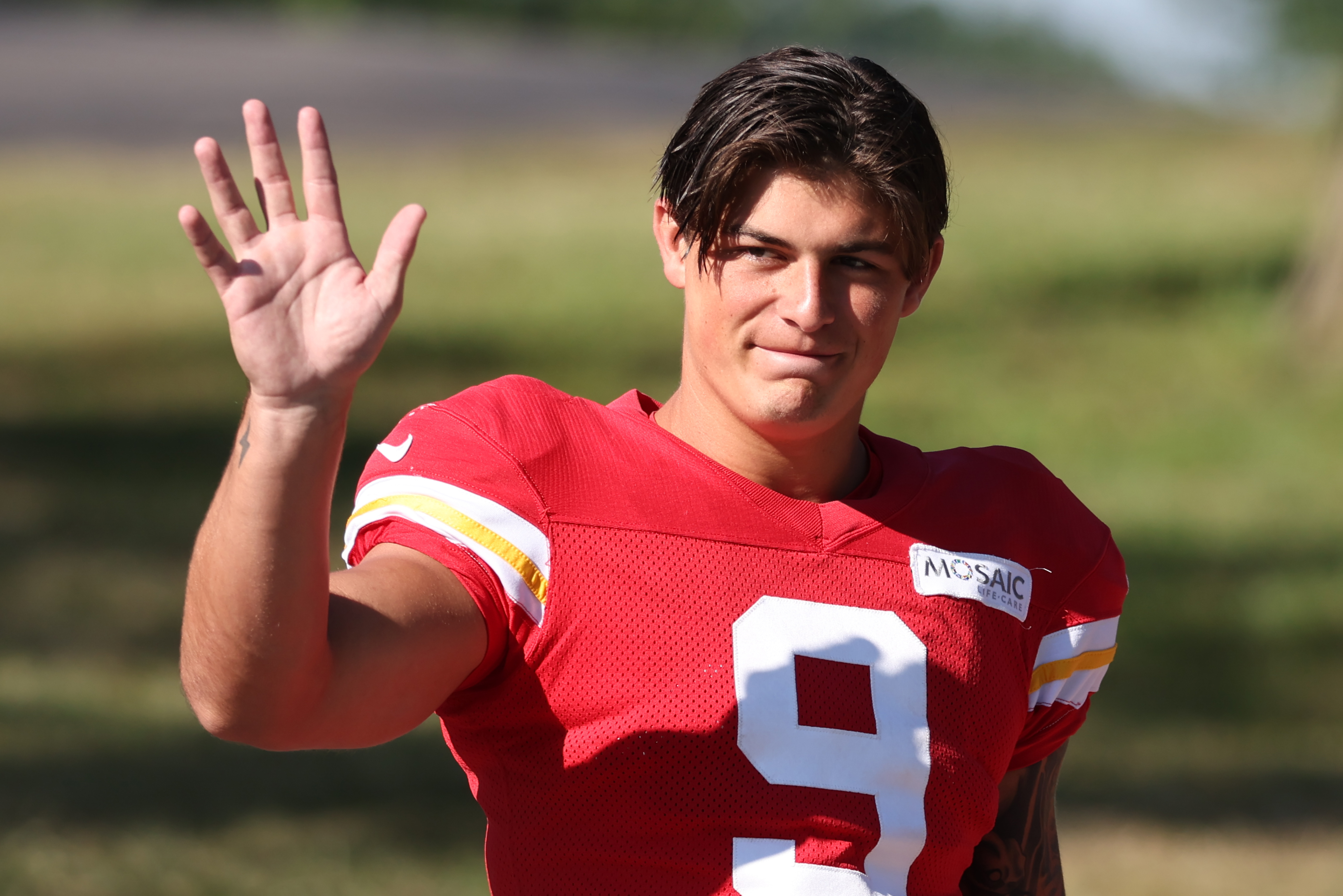 Kansas City Chiefs running back Louis Rees-Zammit waves to fans during training camp at Missouri Western State University.