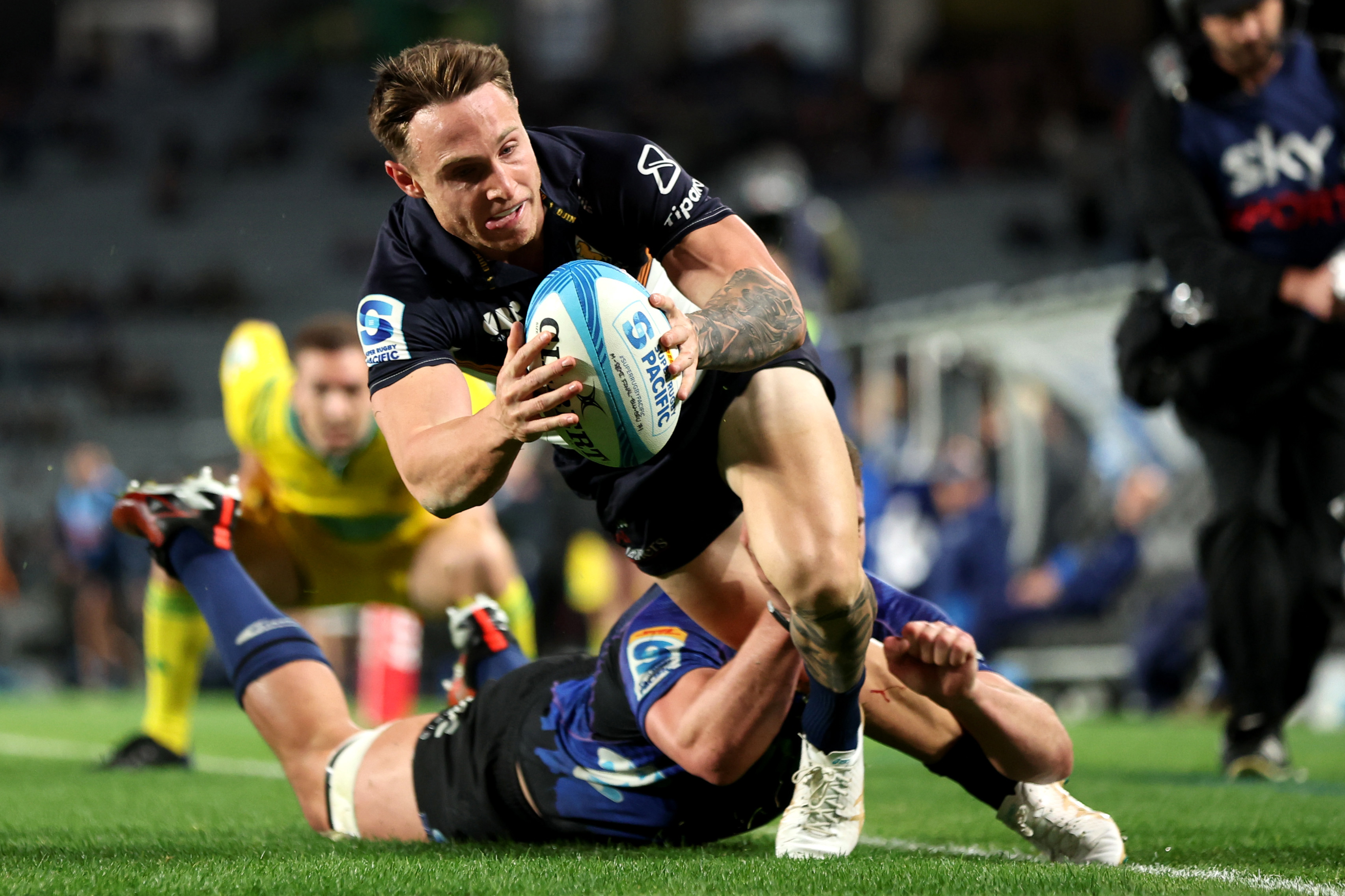 Dalton Papali'i of the Blues tackles Corey Toole of the Brumbies preventing him from scoring a try during the Super Rugby Pacific semi final.