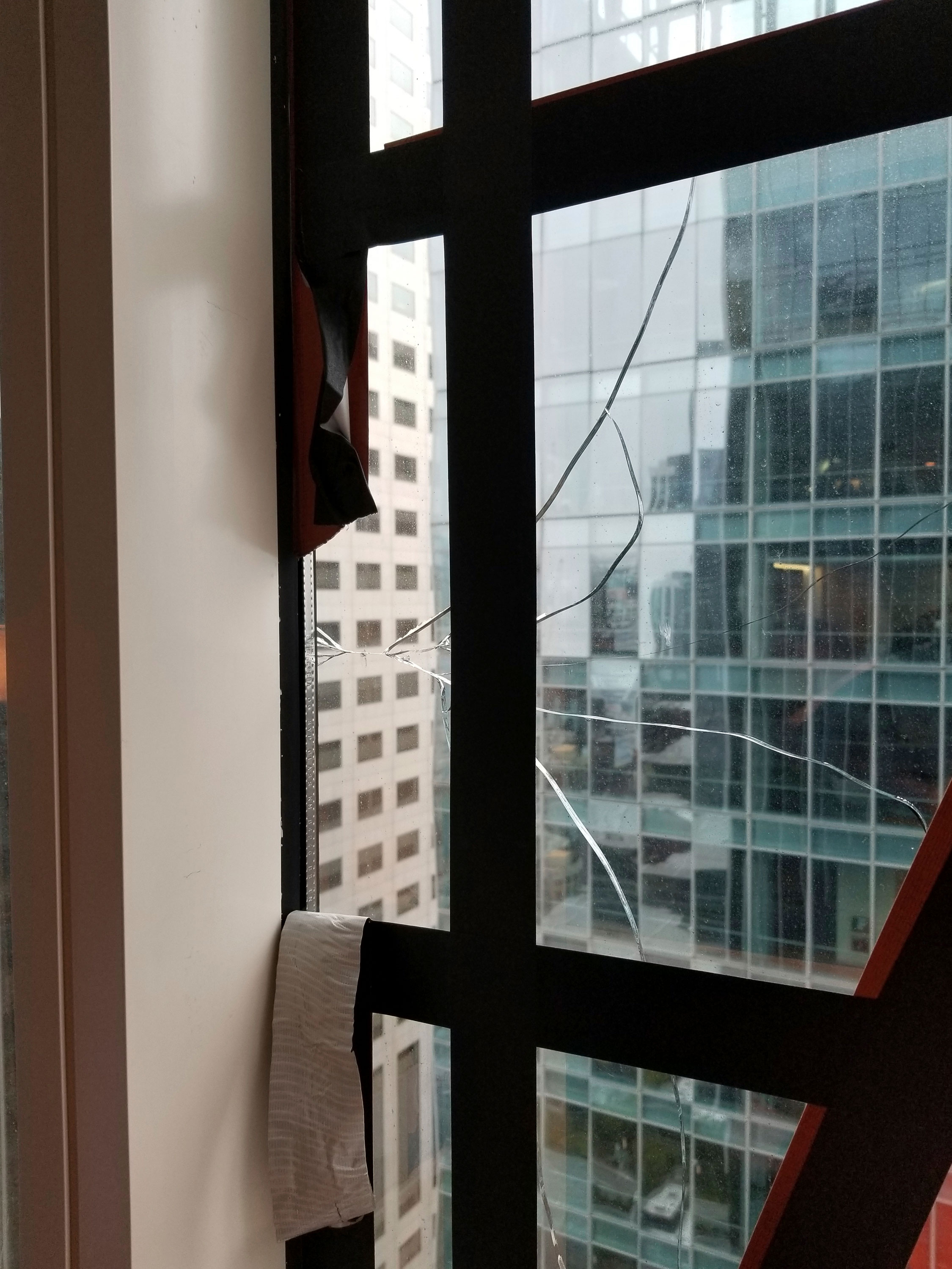 An undated photo provided by the San Francisco Department of Building Inspection shows a window that has cracked in the Millennium Tower.