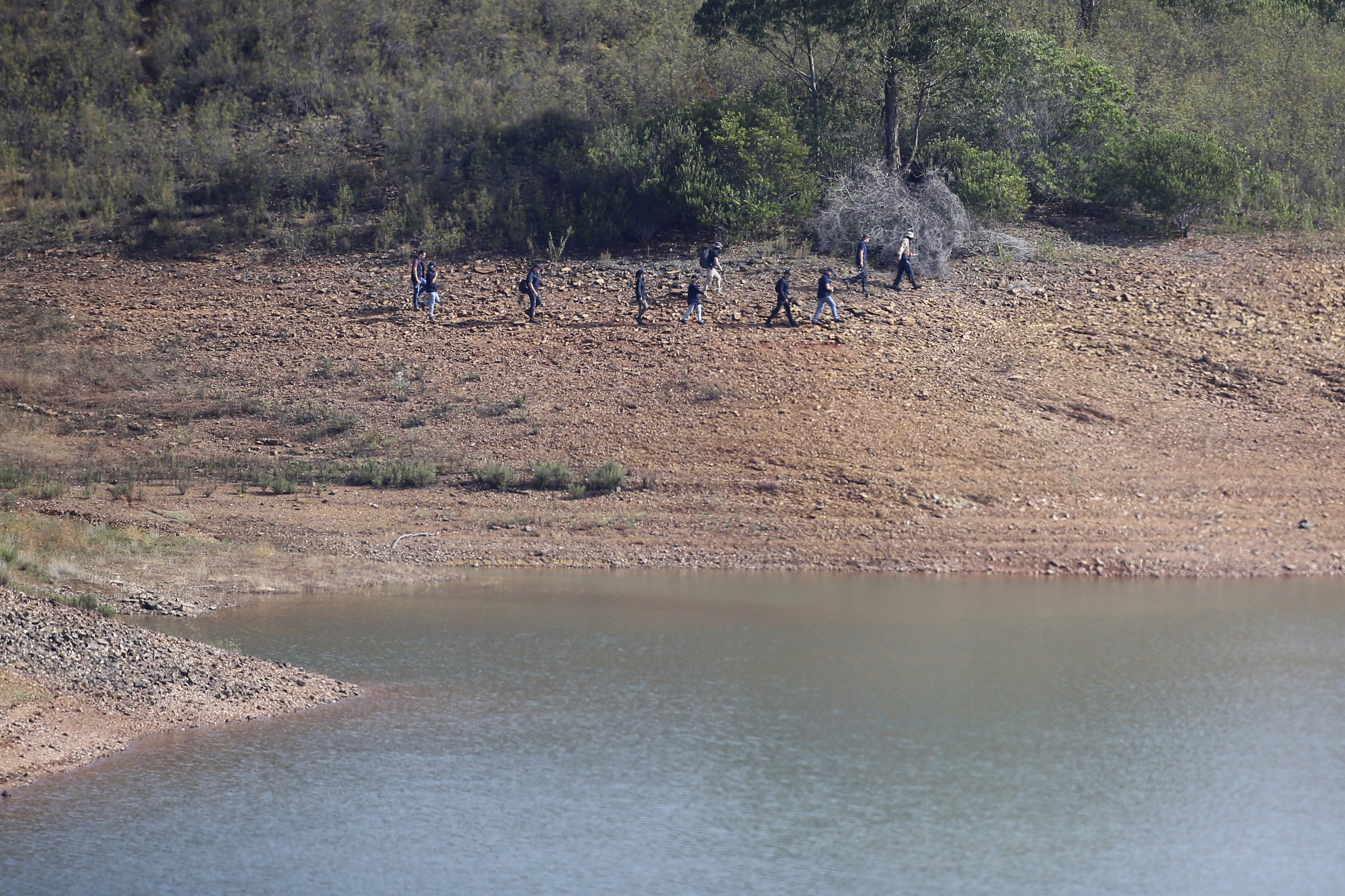 A police search team work on the shore of the Arade dam near Silves, Portugal, Wednesday May 24, 2023.