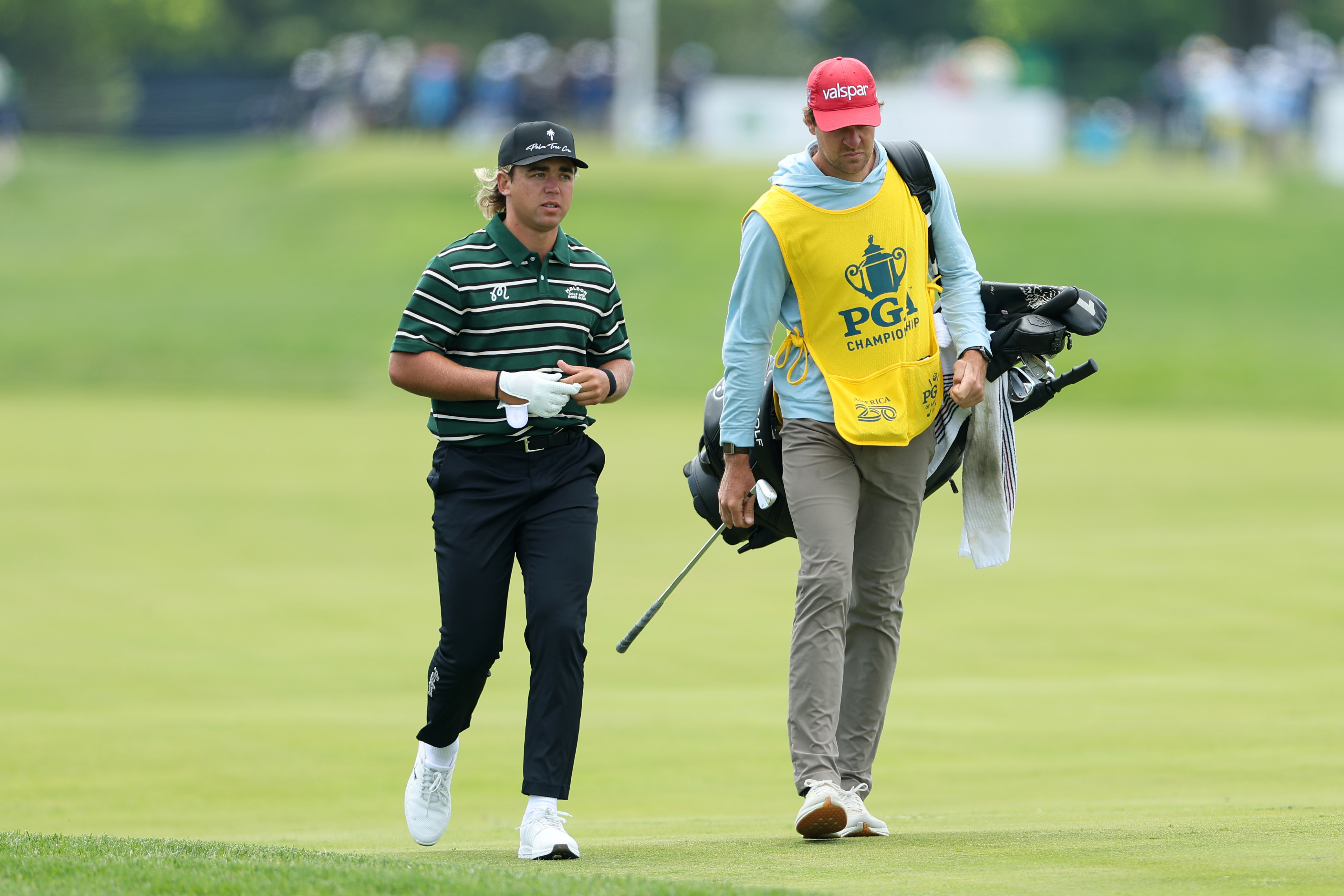 Garrick Higgo of South Africa walks the 16th hole alongside caddie Austin Gaugert.