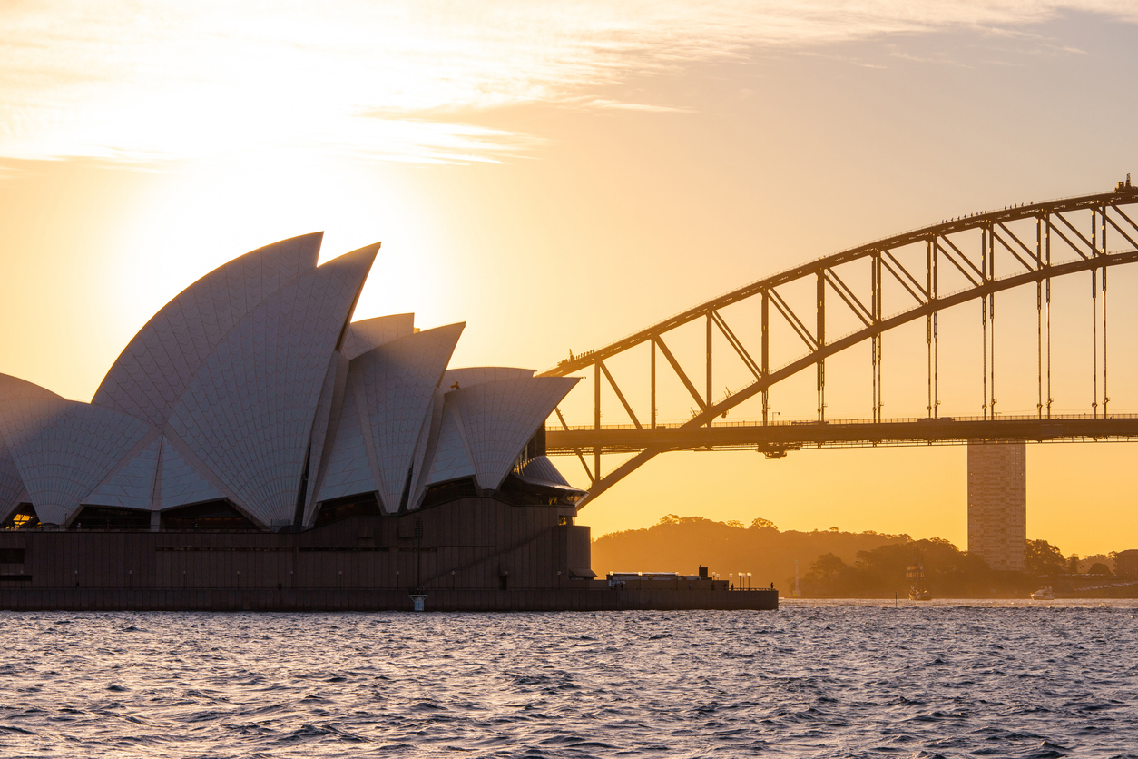 Sydney, Australia - August 10, 2018: Sydney Opera House and Sydney Harbour Bridge under the sunset light.