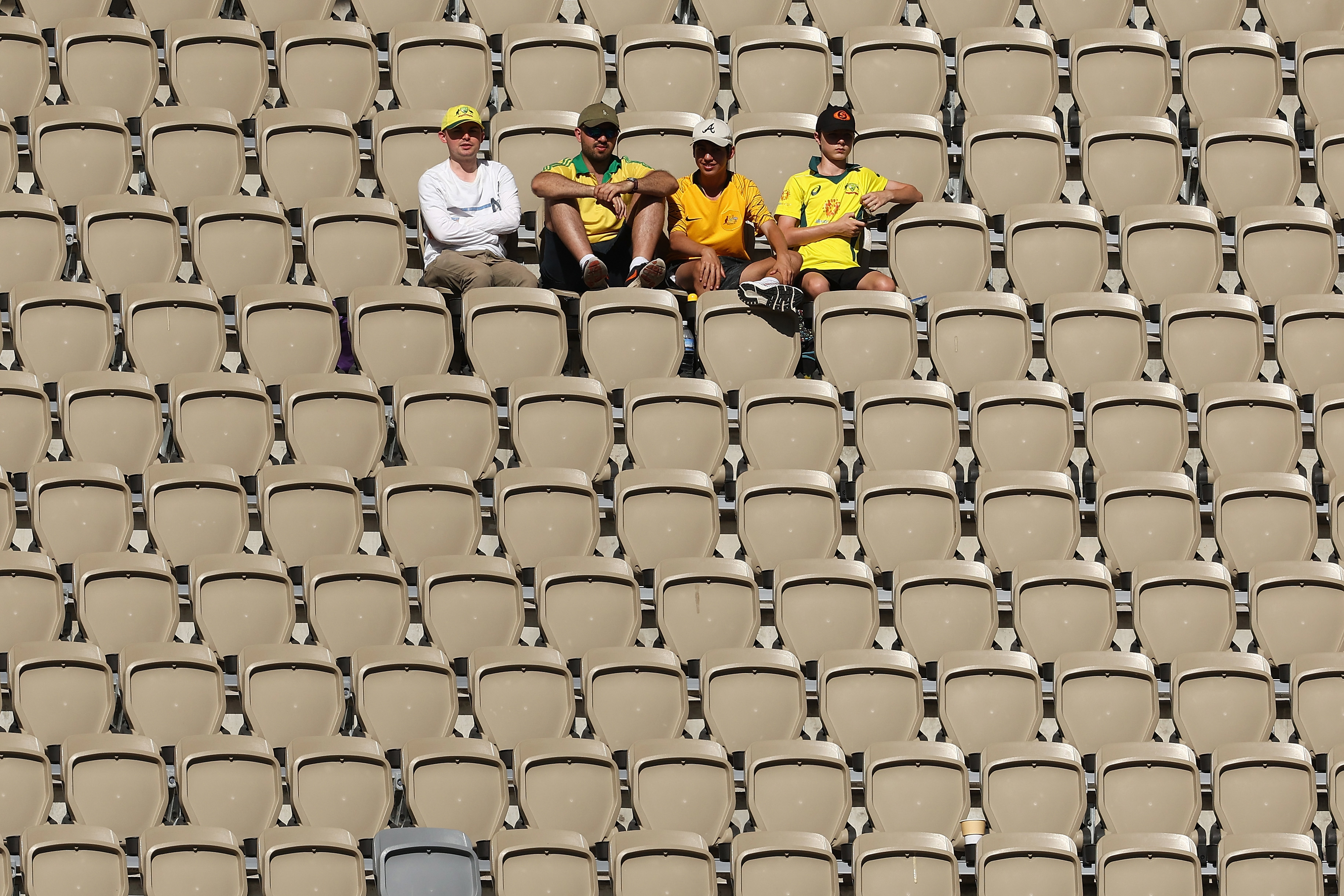 A handful of fans sit inside Perth Stadium on day four of the Test between Australia and Pakistan.