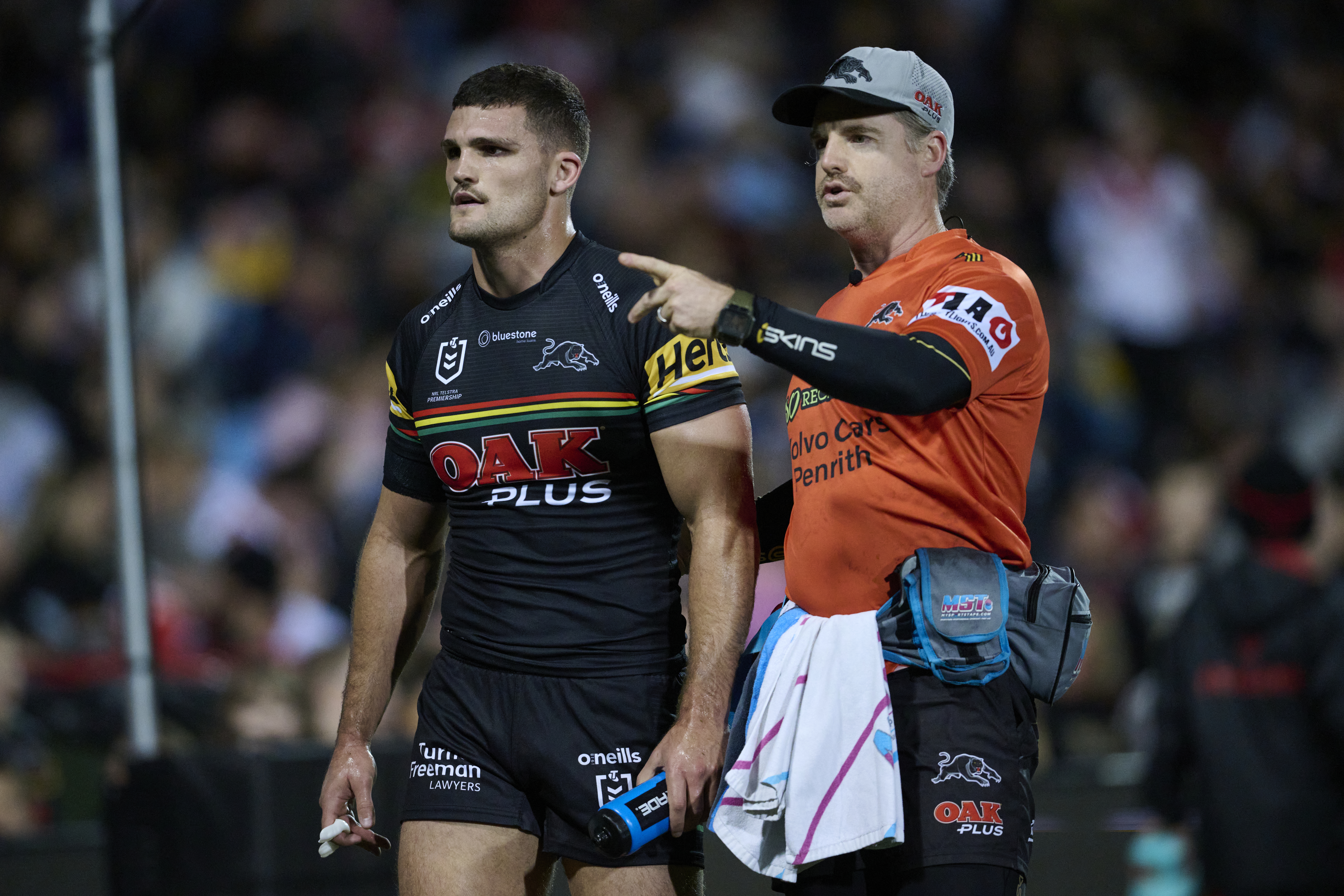 Nathan Cleary is assisted off the field by a Panthers trainer after suffering a hamstring injury