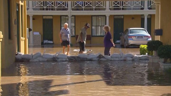Locals in Ballina check sandbags after the Richmond river burst its banks.