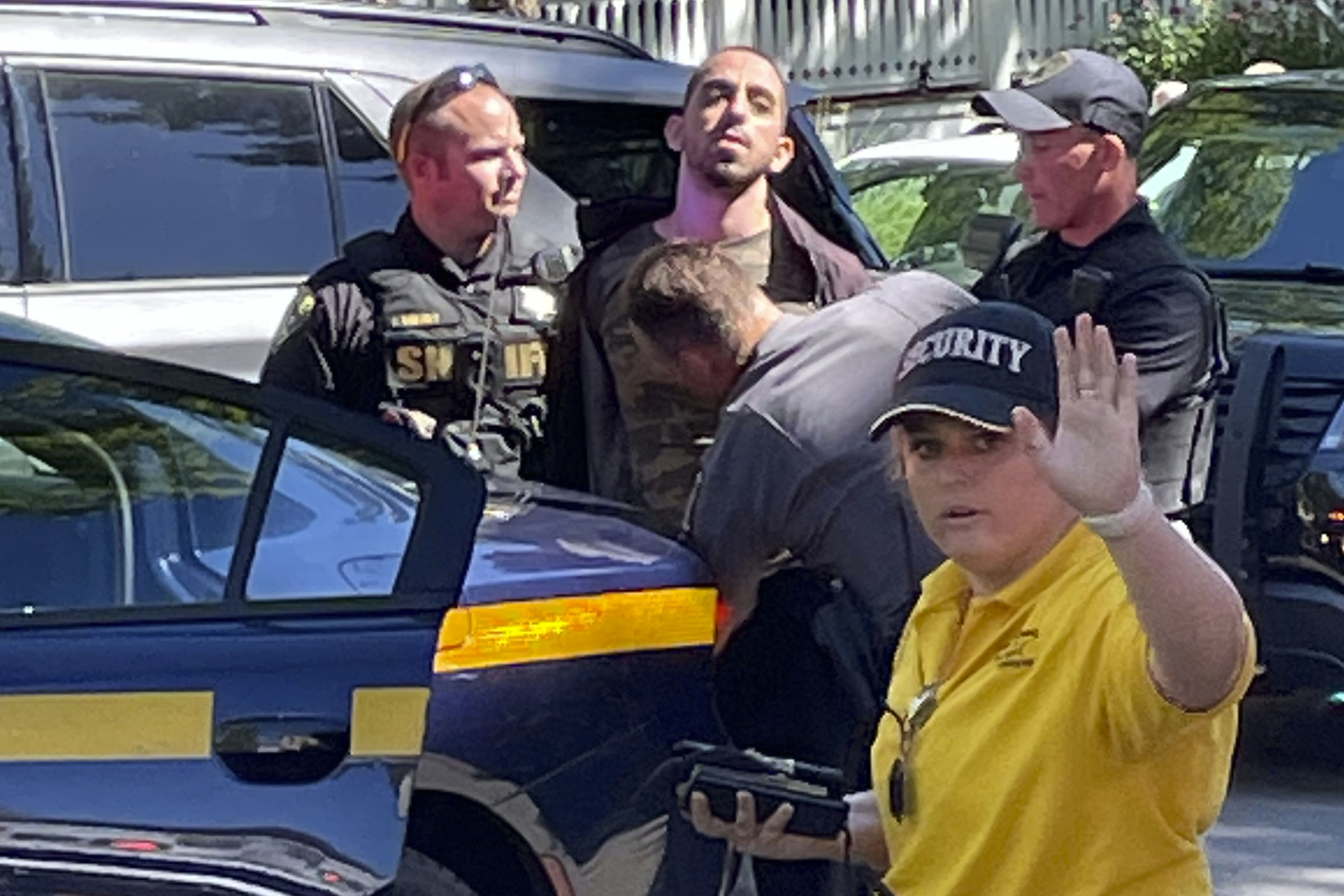 Law enforcement officers detain a person outside the Chautauqua Institution, Friday, Aug. 12, 2022, in Chautauqua, N.Y.